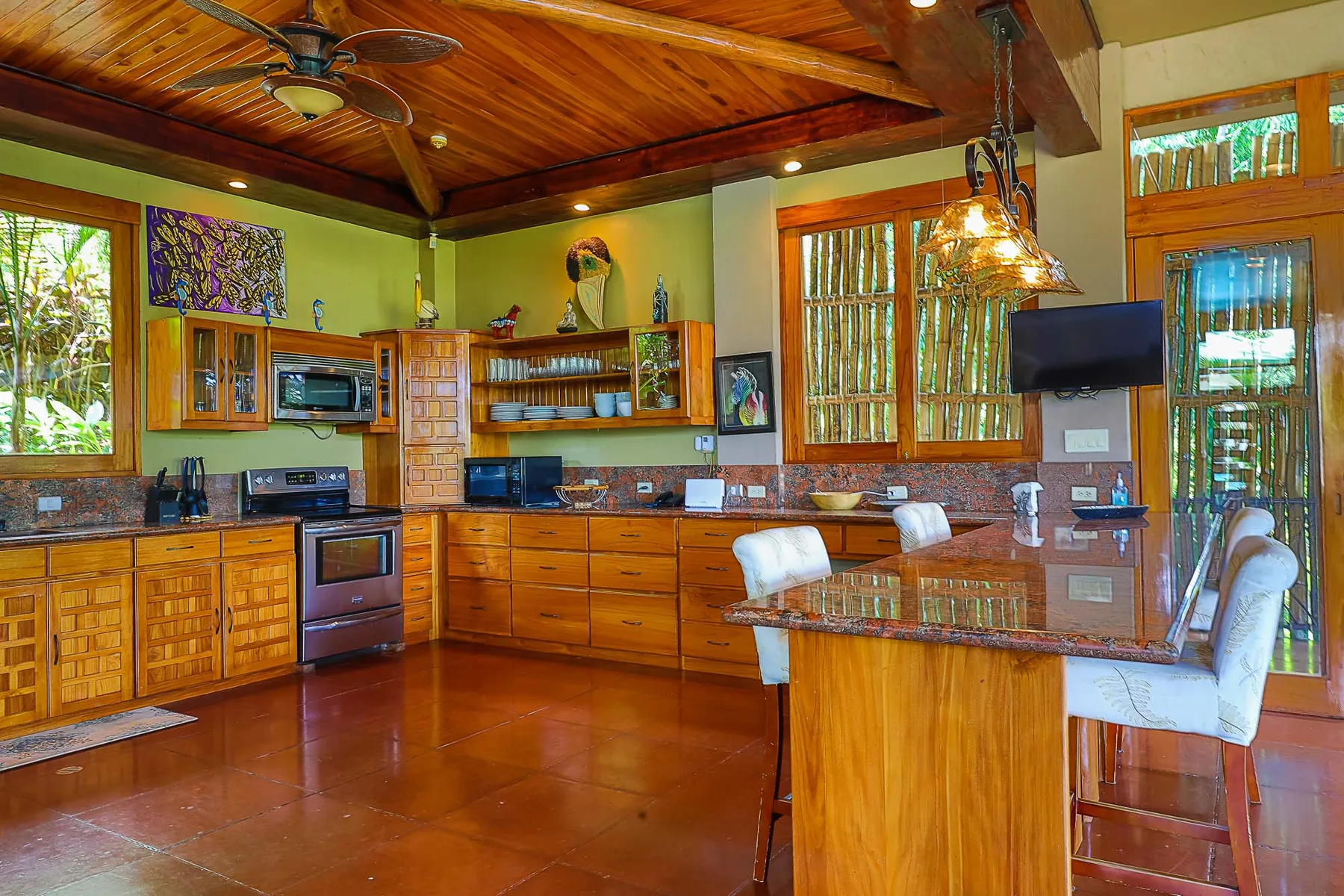 A spacious kitchen with wooden cabinets and a dining table.