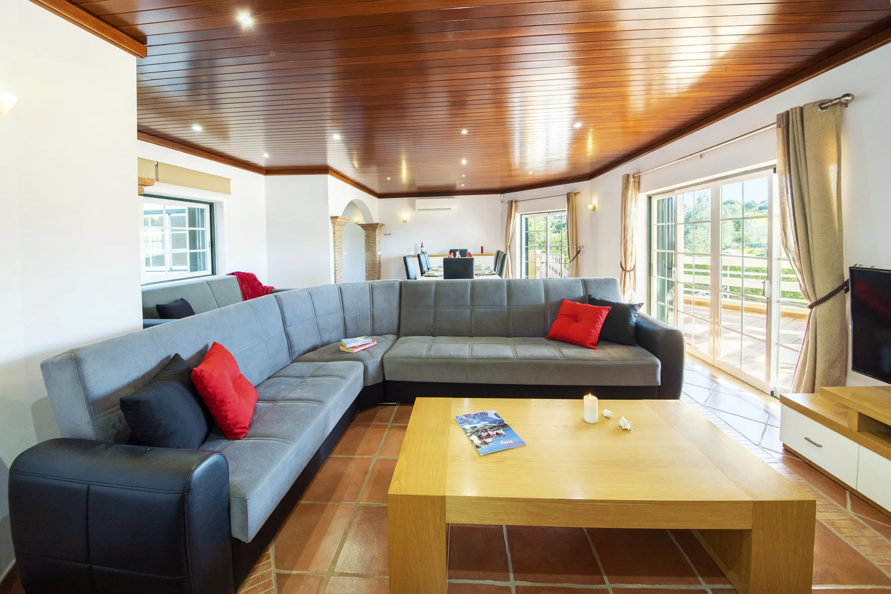 A living room with an L-shaped seating area and a wooden coffee table.