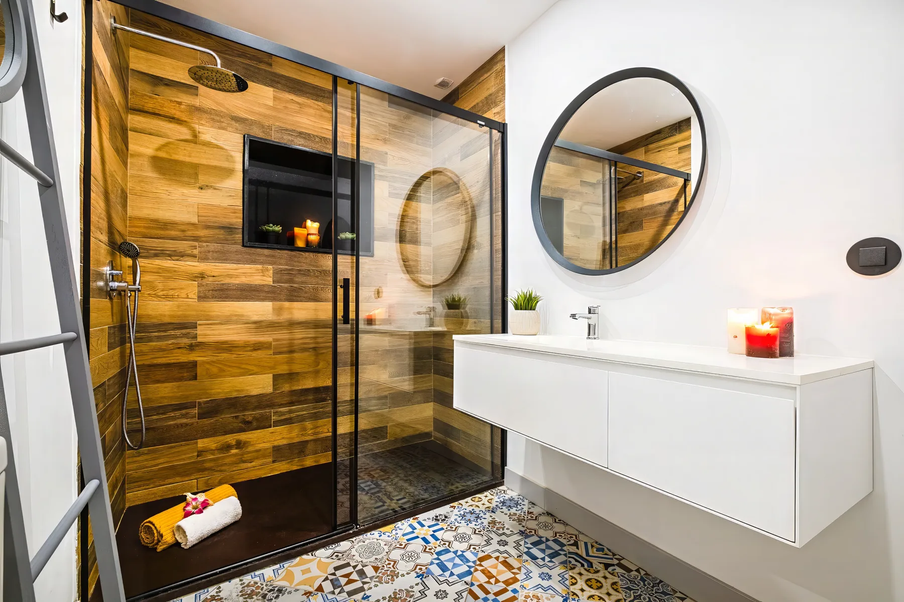 A modern bathroom with a glass shower and a floating white vanity.