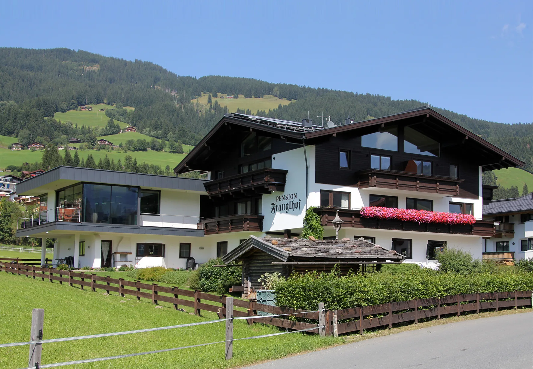 Zona común: Un edificio de estilo chalet se encuentra junto a una ladera verde.