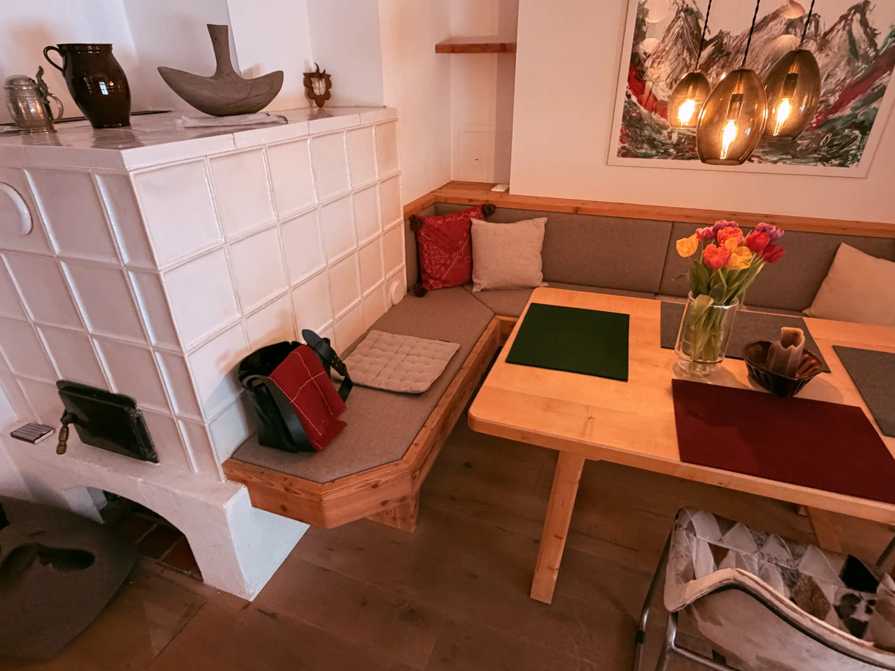 A cozy living room with a tiled fireplace, low table, and seating.