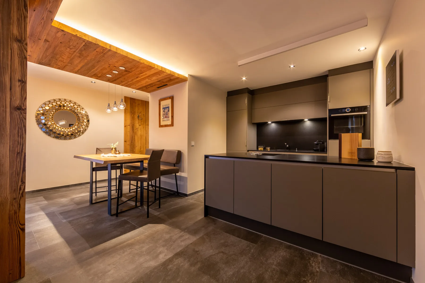 An open-plan kitchen and dining area with a table beside the kitchen island.