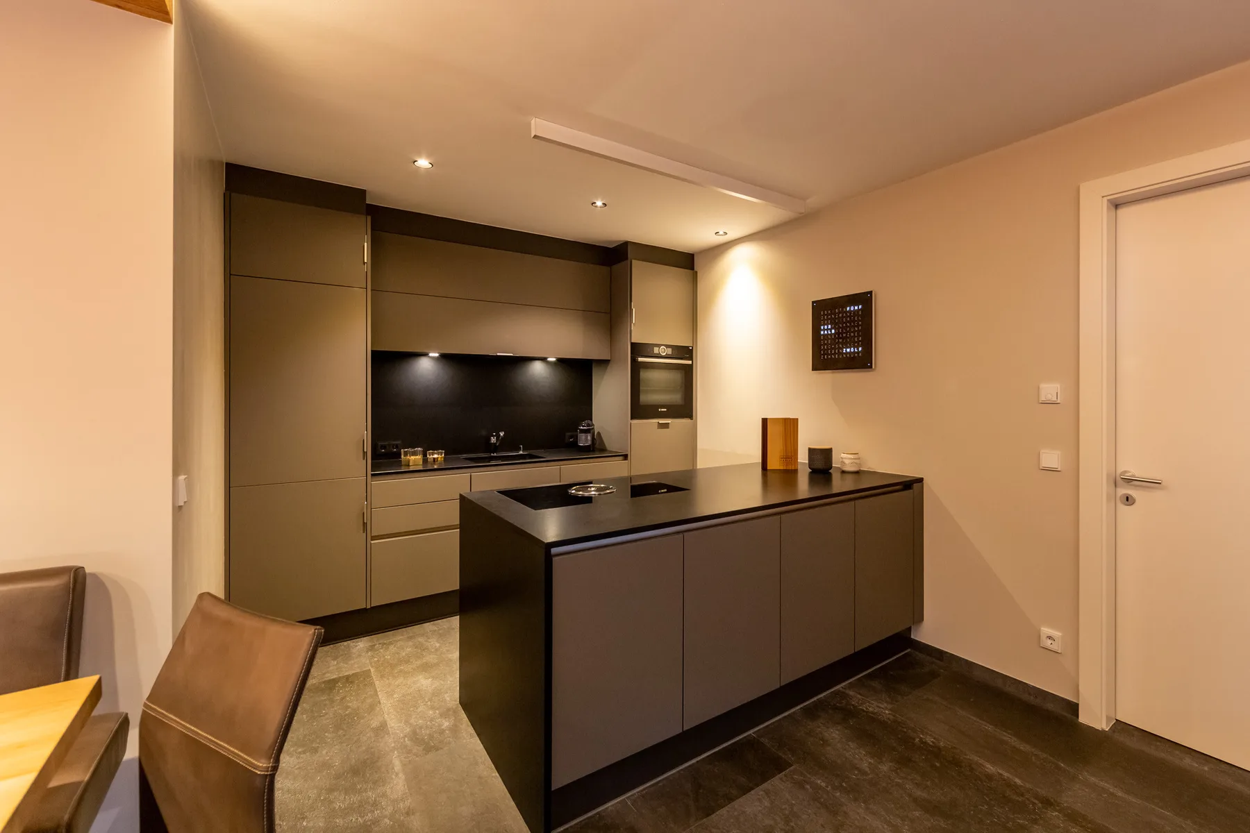 A modern kitchen with dark cabinetry and a central island.
