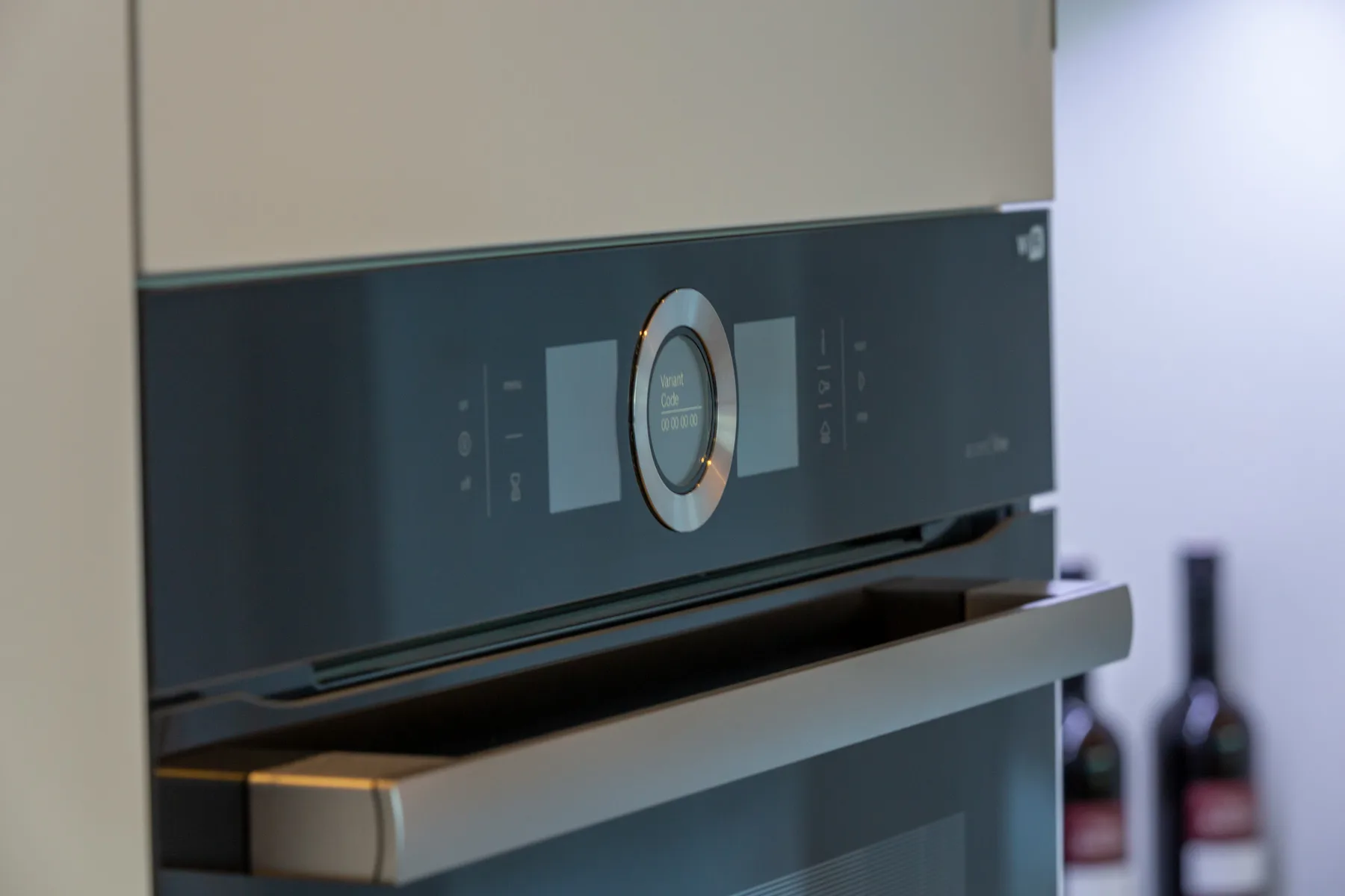 A built-in oven with a digital control panel is set into kitchen cabinetry.