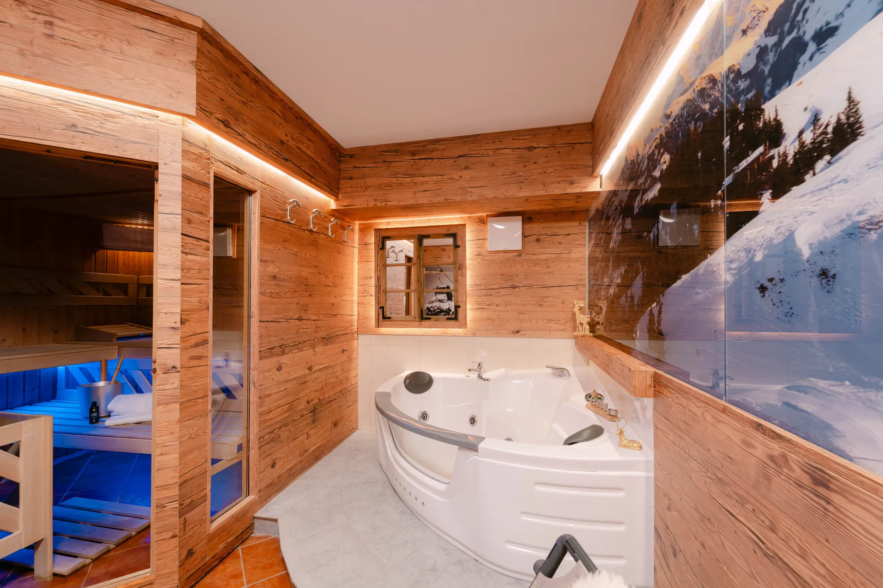 Un espacio de spa revestido de madera con bañera esquinera y sauna contigua.