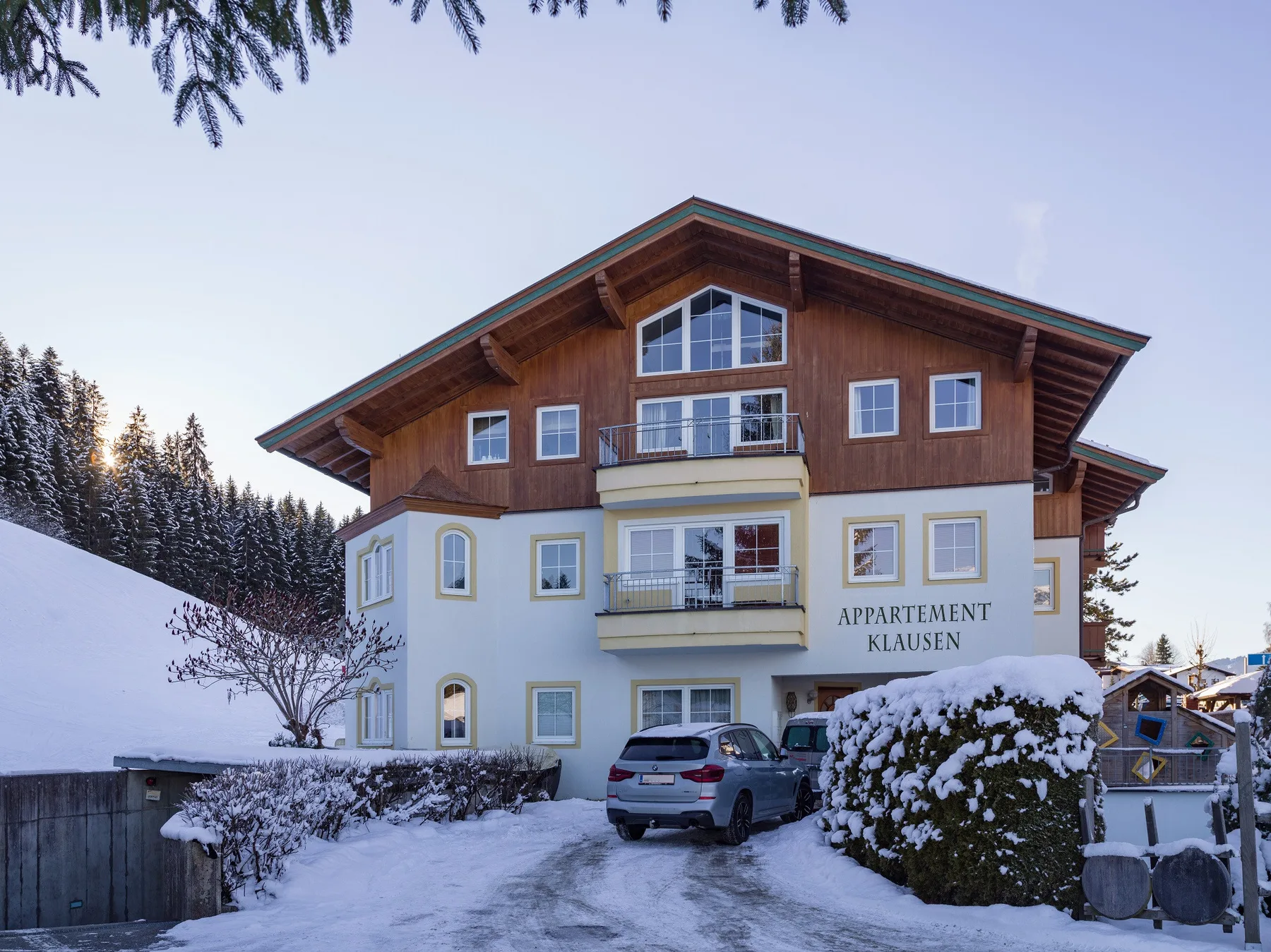 Zona común: Un edificio de estilo chalet está junto a una entrada cubierta de nieve.