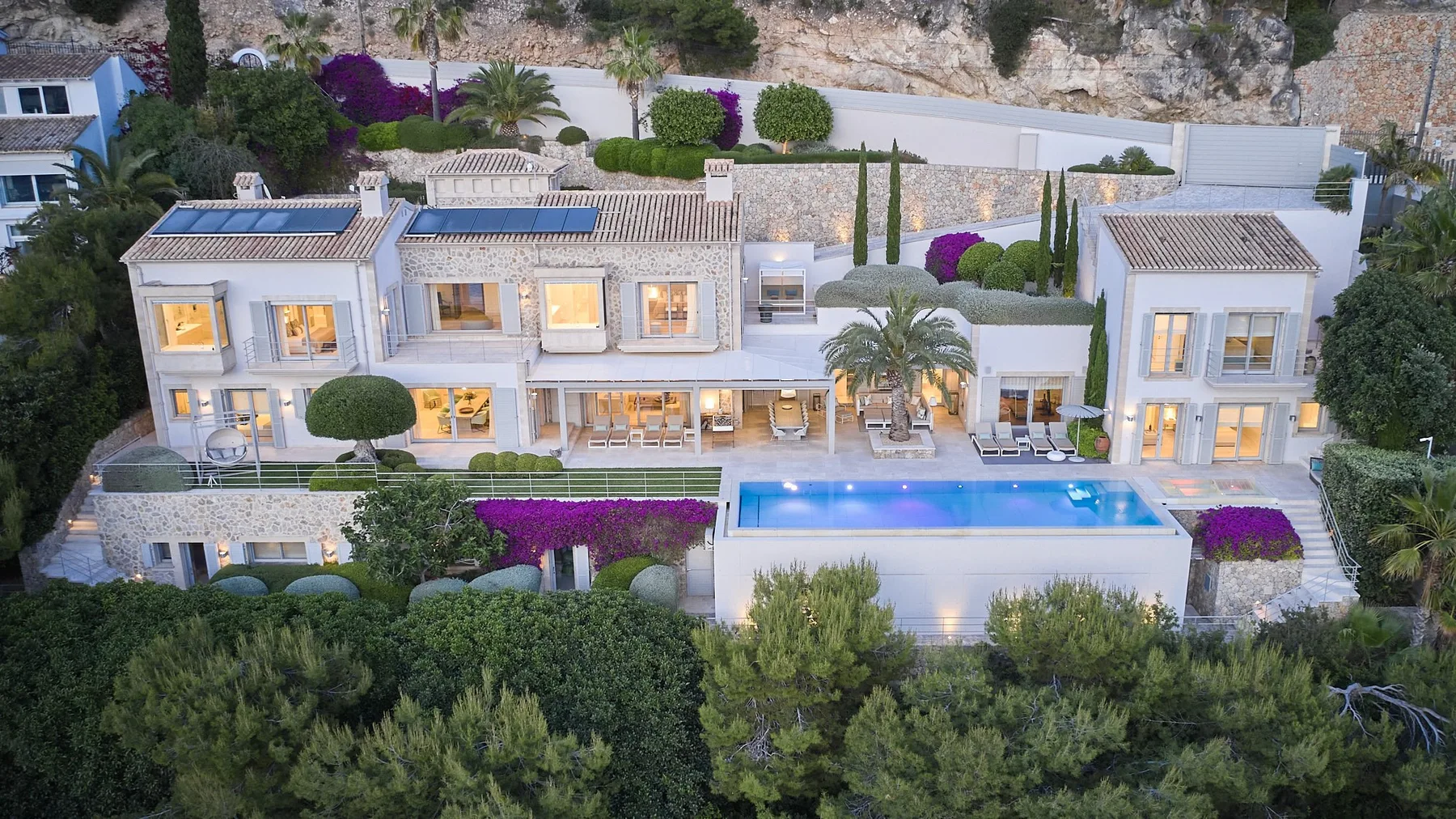 A large residence with a swimming pool and landscaped gardens.