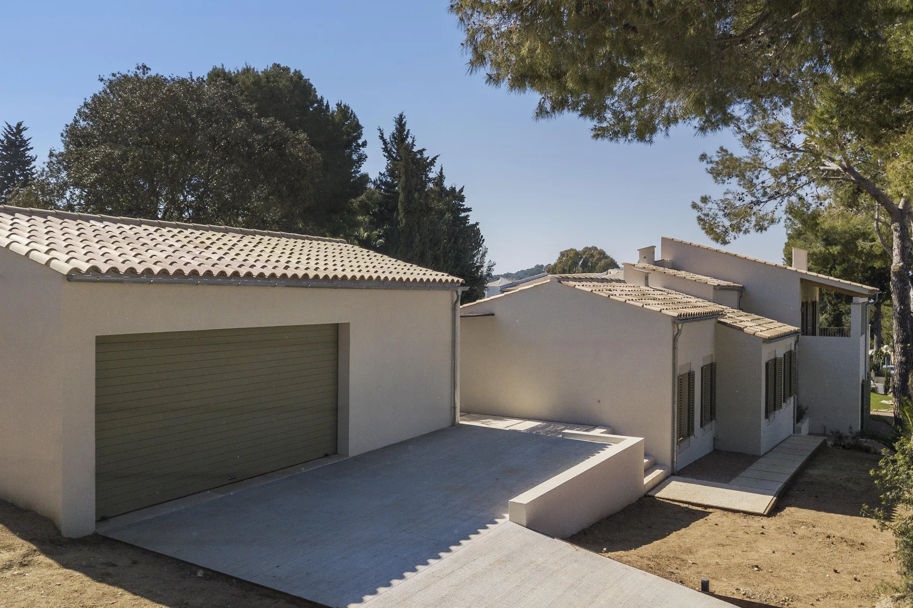 A single-story house with a tiled roof and an attached garage.