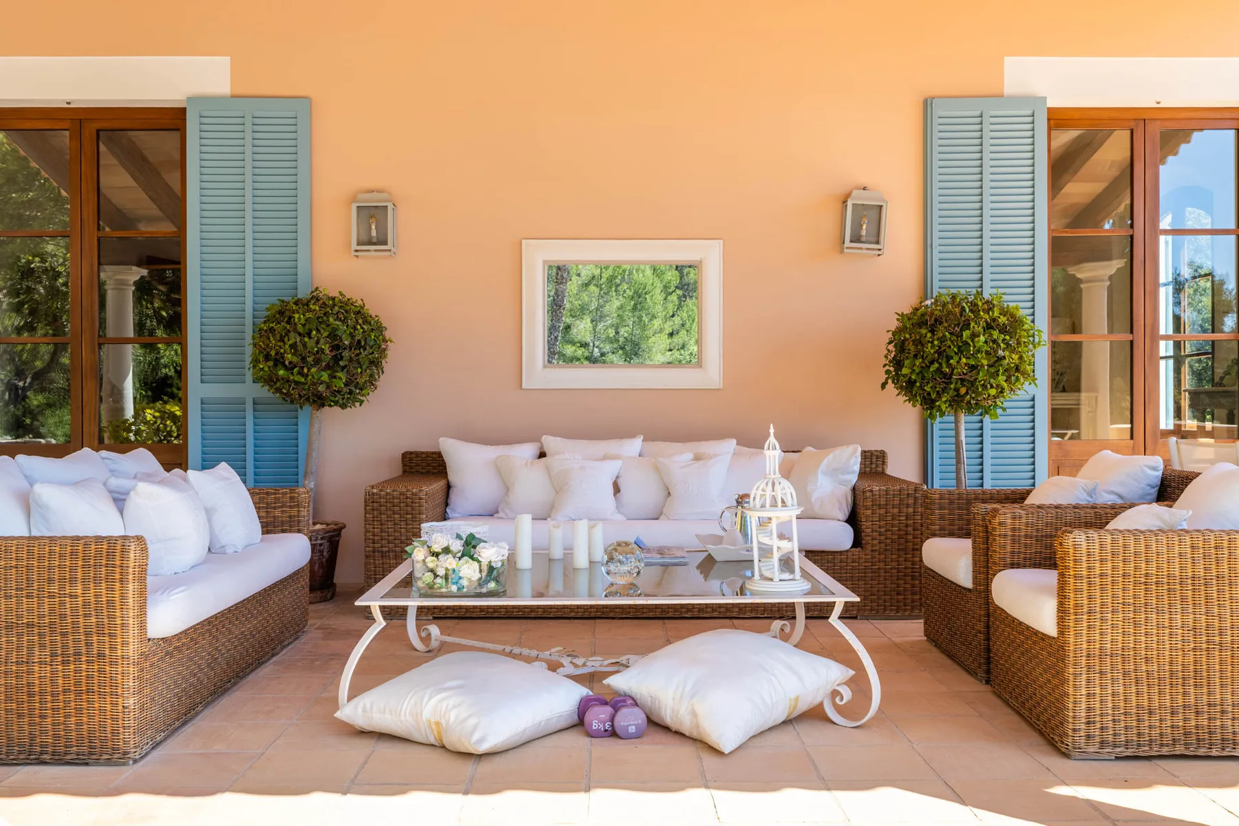 A furnished patio seating area with wicker seating and a low table.