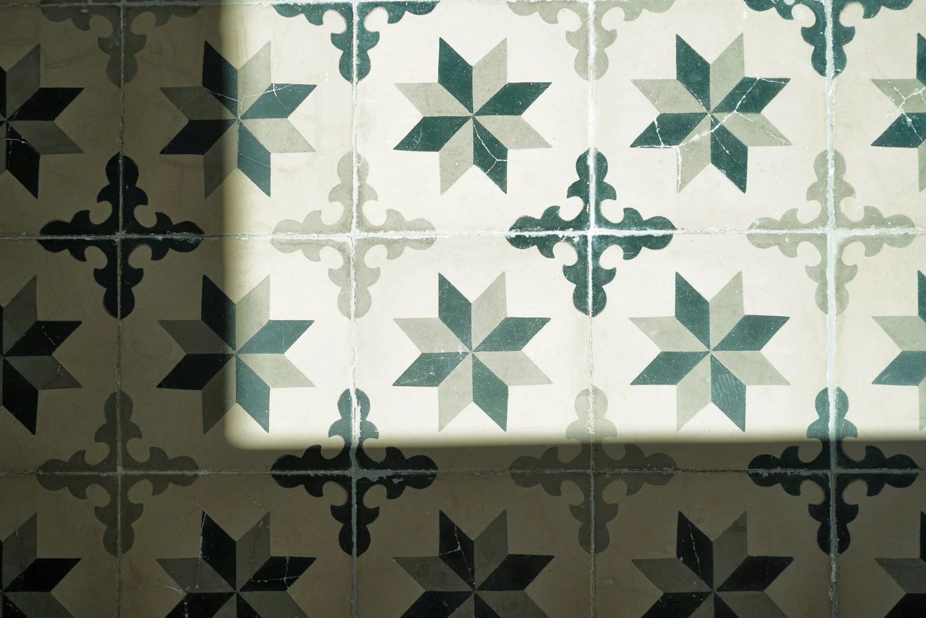 Decorative floor tiles feature repeating star patterns in contrasting shades.