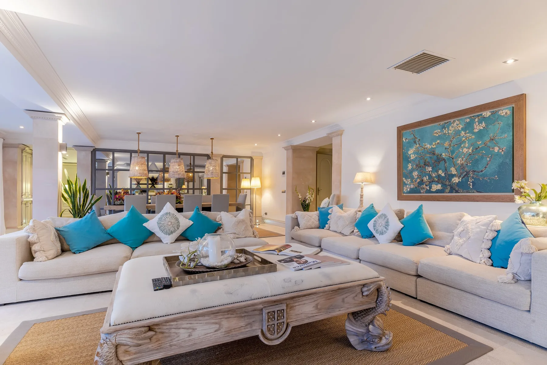 Bright living room with pale seating and a large coffee table.