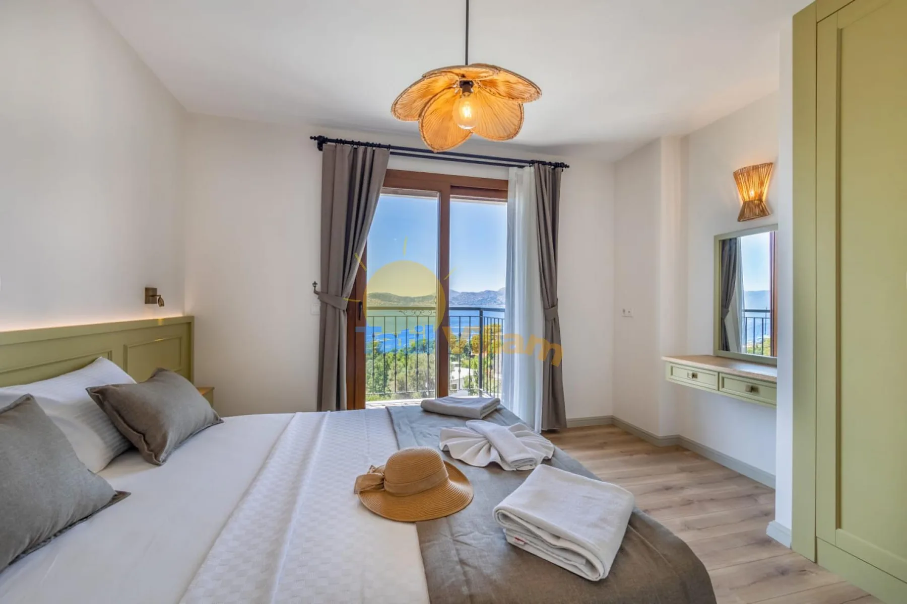 A bright bedroom with a bed, bedside lighting, and a glass door opening to a balcony.