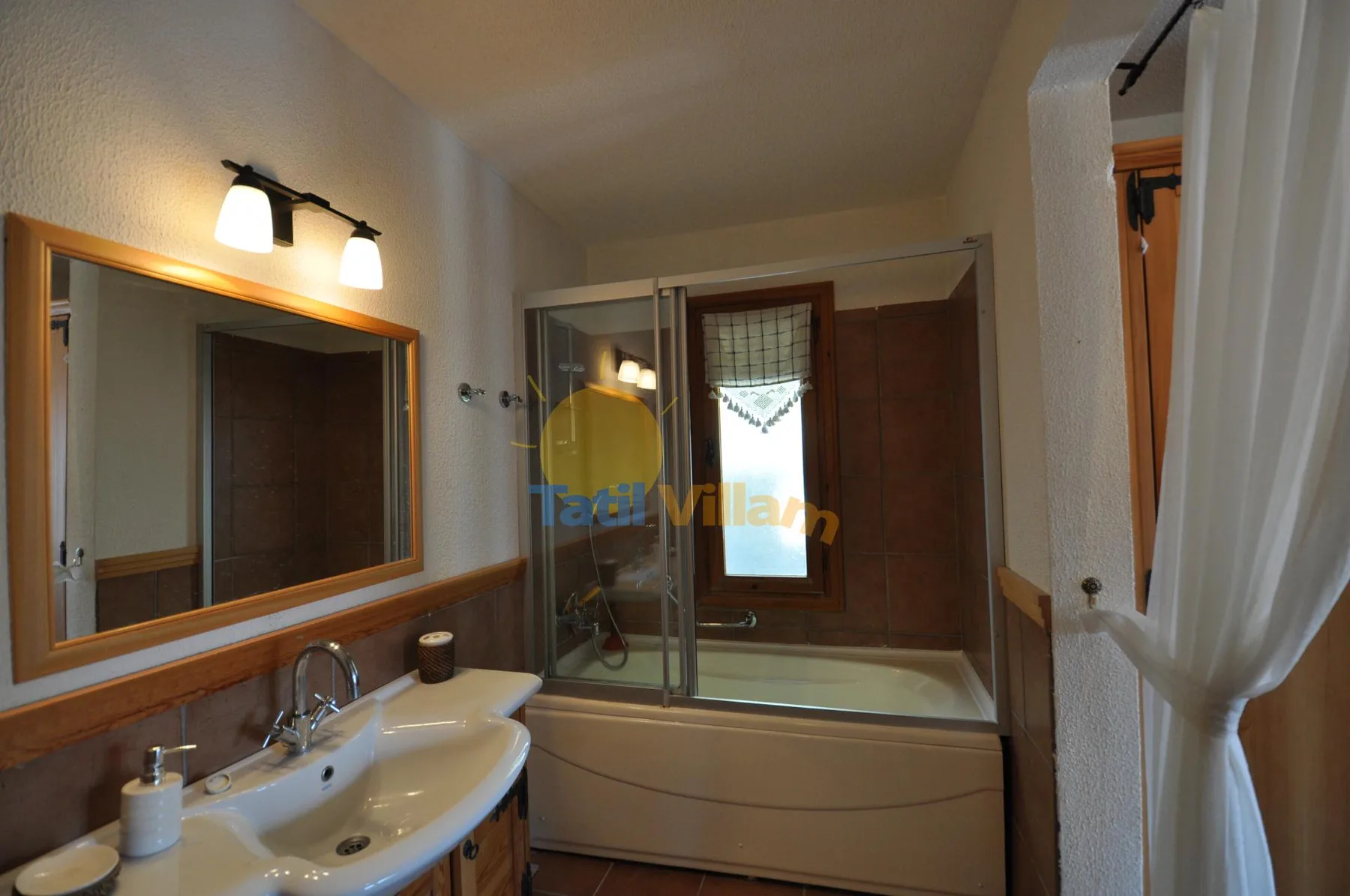 A bathroom with a sink and a bathtub-shower combination.