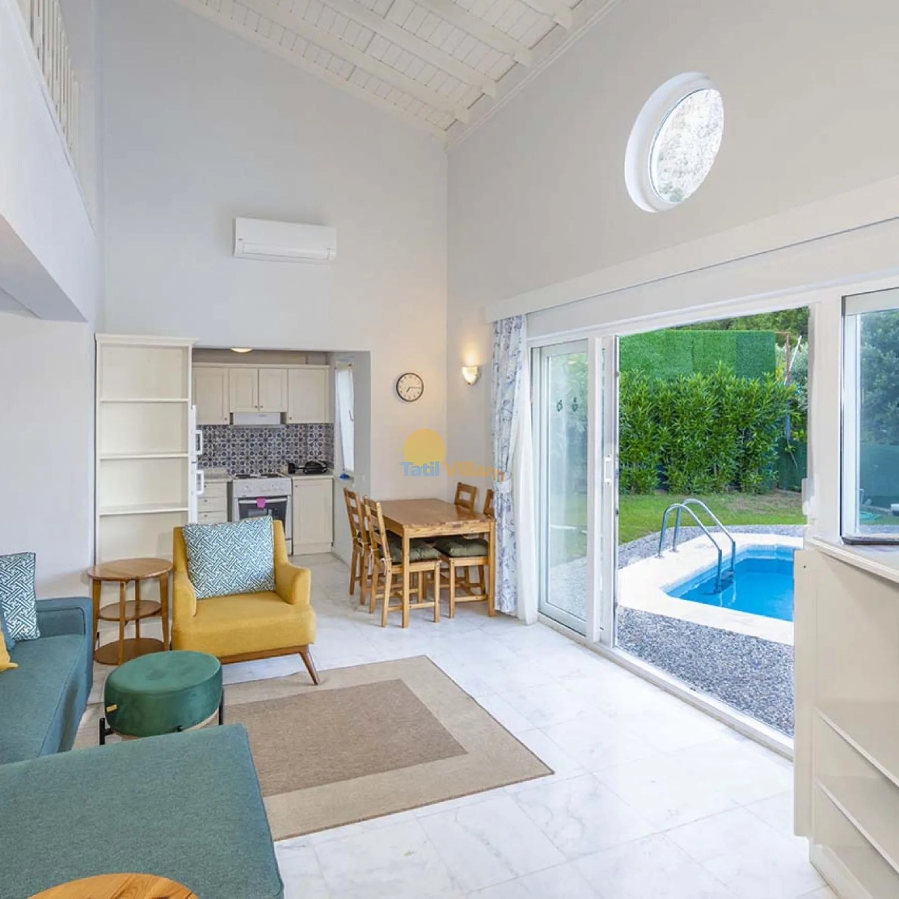 Una luminosa sala de estar y comedor se abre a un patio con piscina.