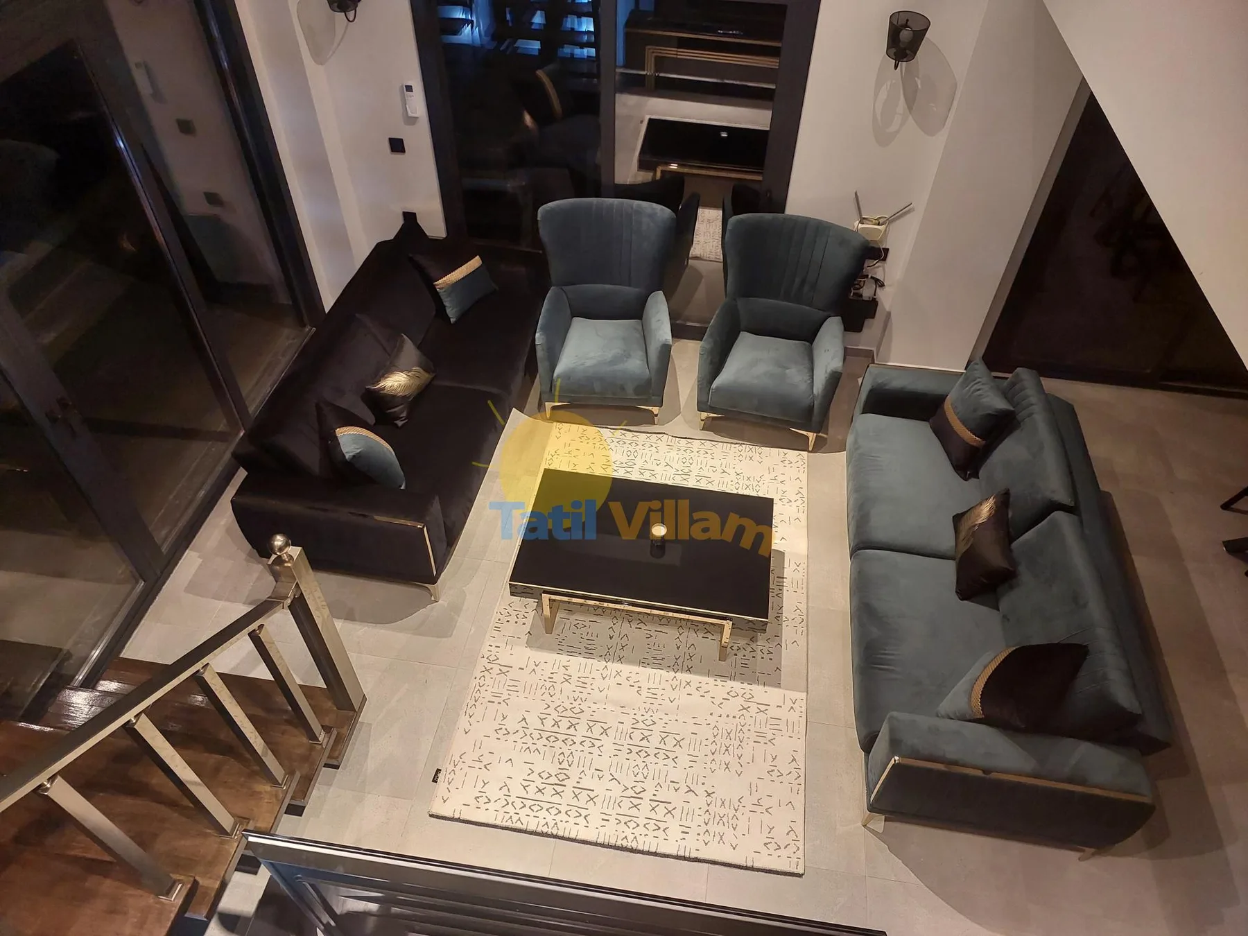 Una sala de estar con asientos alrededor de una mesa de centro y una alfombra.