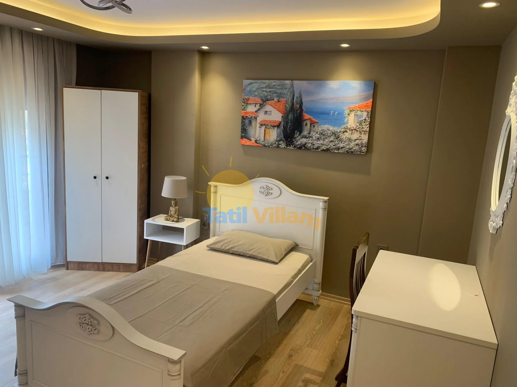 A bedroom with a single bed, a wardrobe, and a desk.