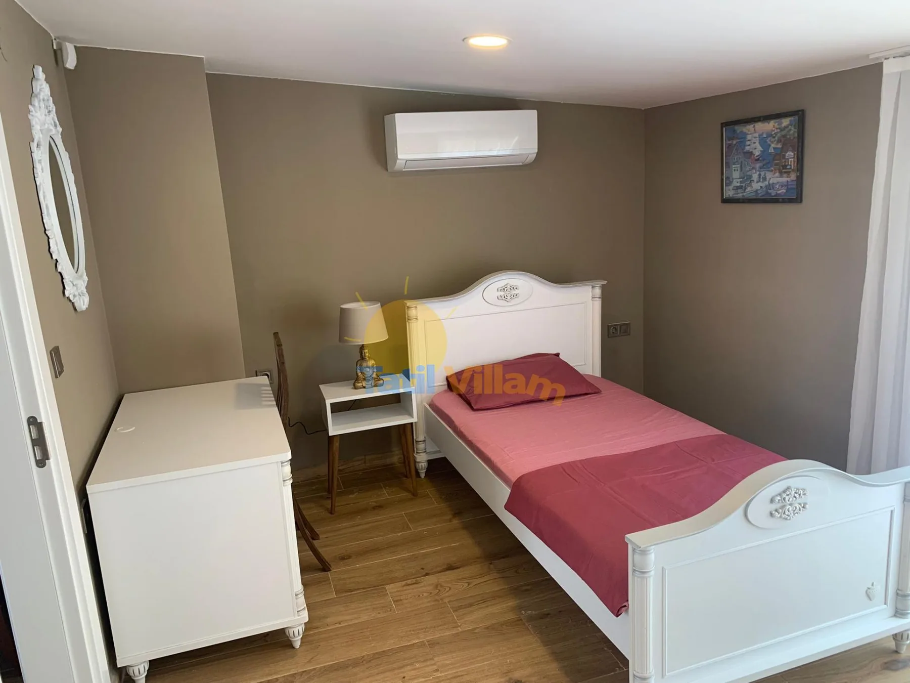 A bedroom with a single bed, a bedside table, and a white dresser.
