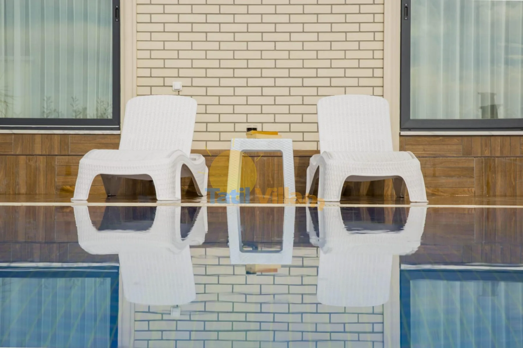 A patio seating area with white chairs beside a small table.