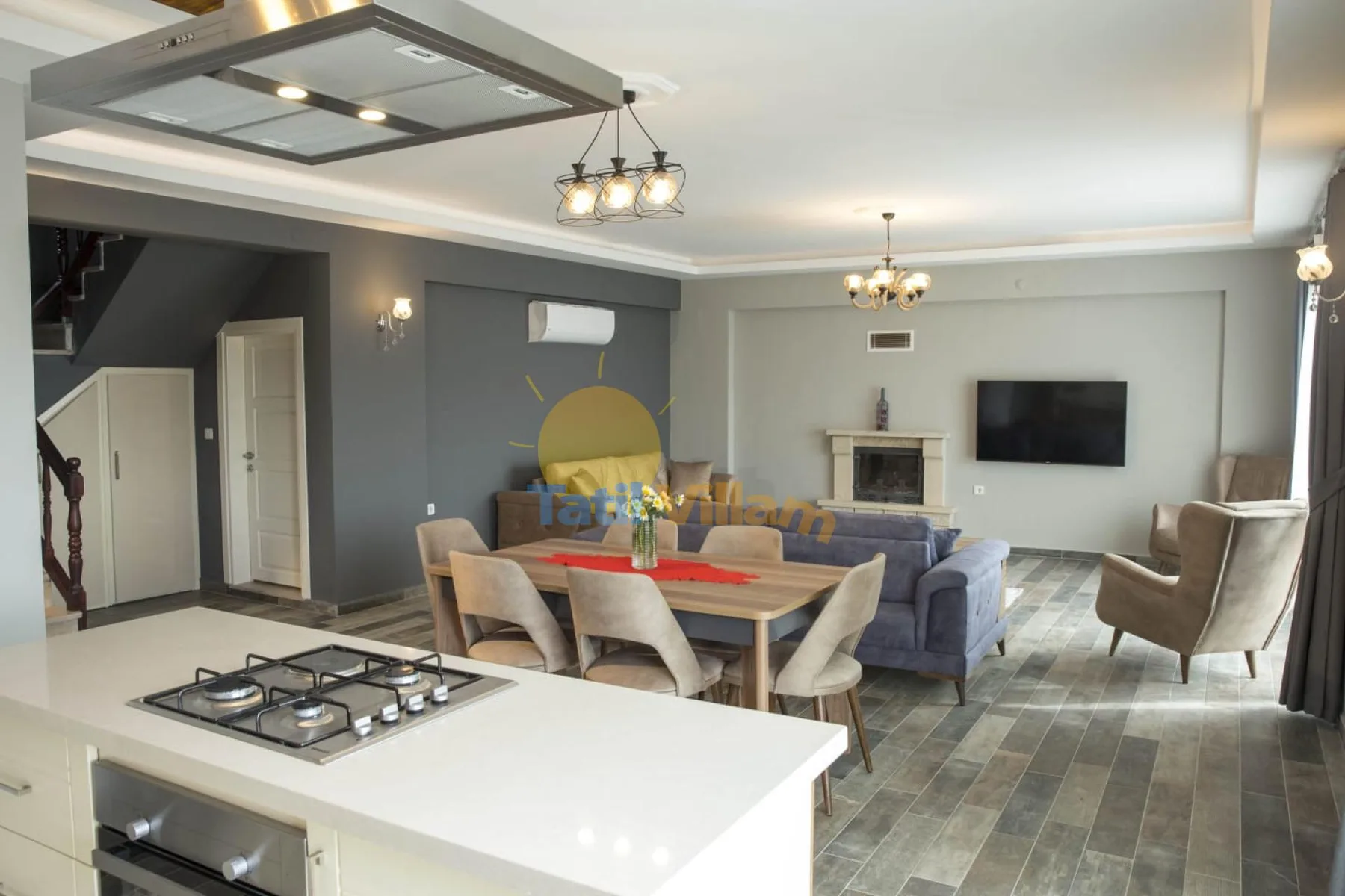 An open-plan living room and kitchen with a dining table and seating.