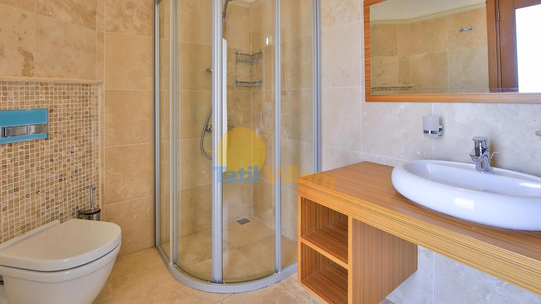 A tiled bathroom with a glass shower, toilet, and wooden vanity.