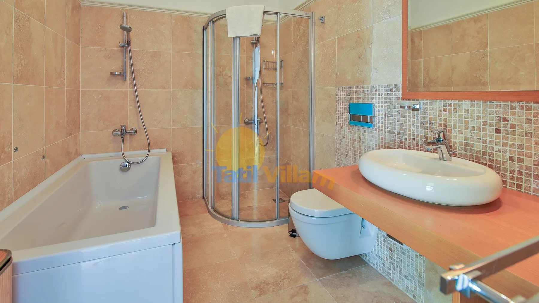 A tiled bathroom with a bathtub, shower, sink, and toilet.