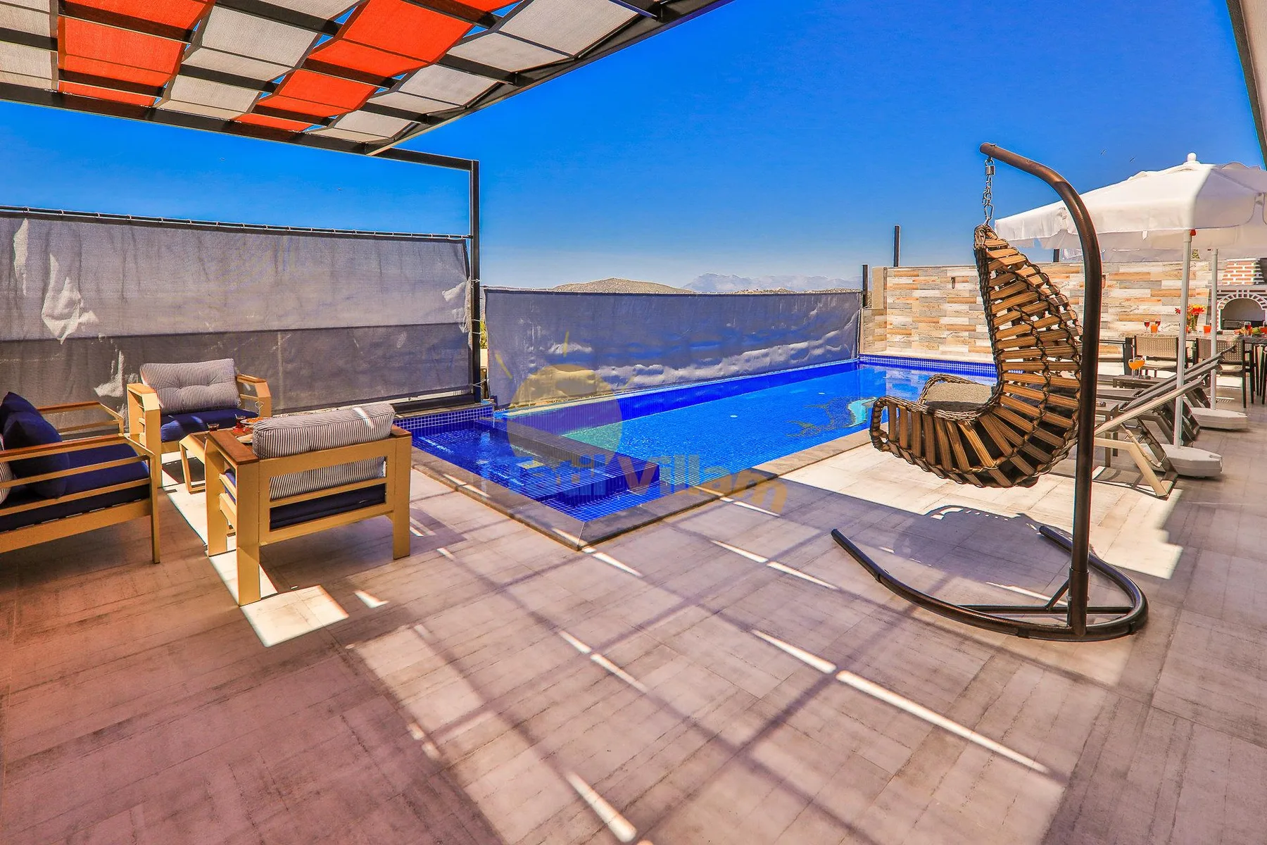 A rooftop pool deck with lounge seating and a suspended chair under a canopy.