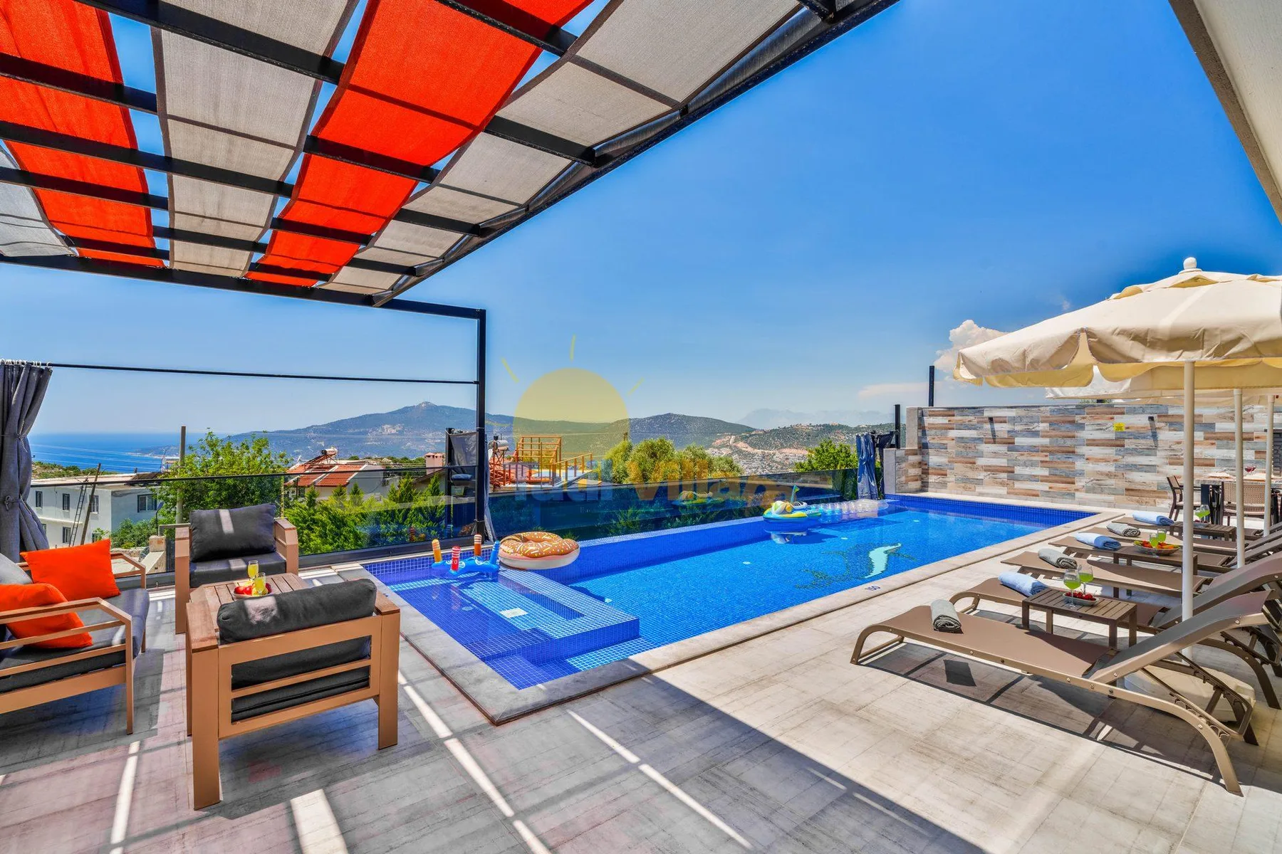 An outdoor swimming pool with lounge seating and a view of the hills.