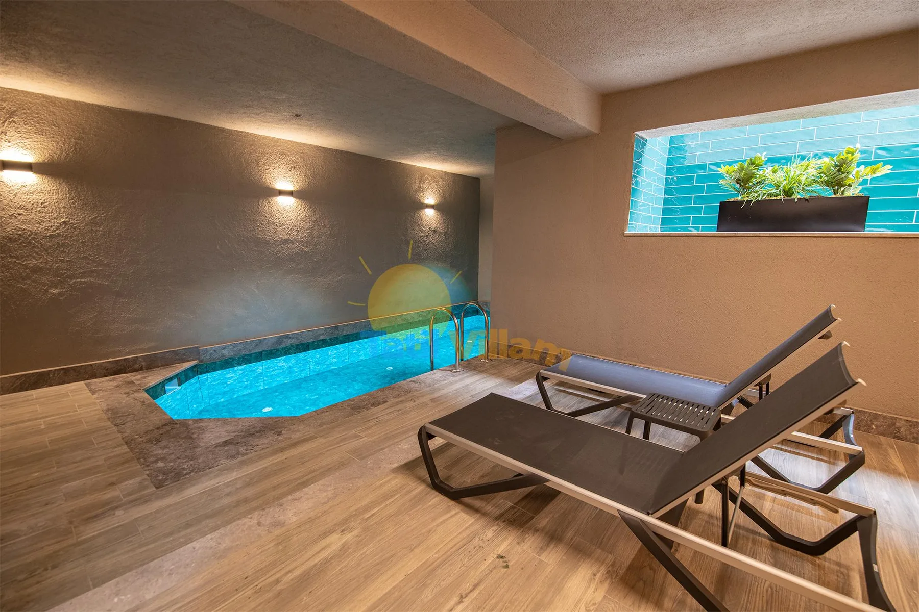 An indoor pool area features a small turquoise pool, wood-look flooring, and reclining lounge chairs.