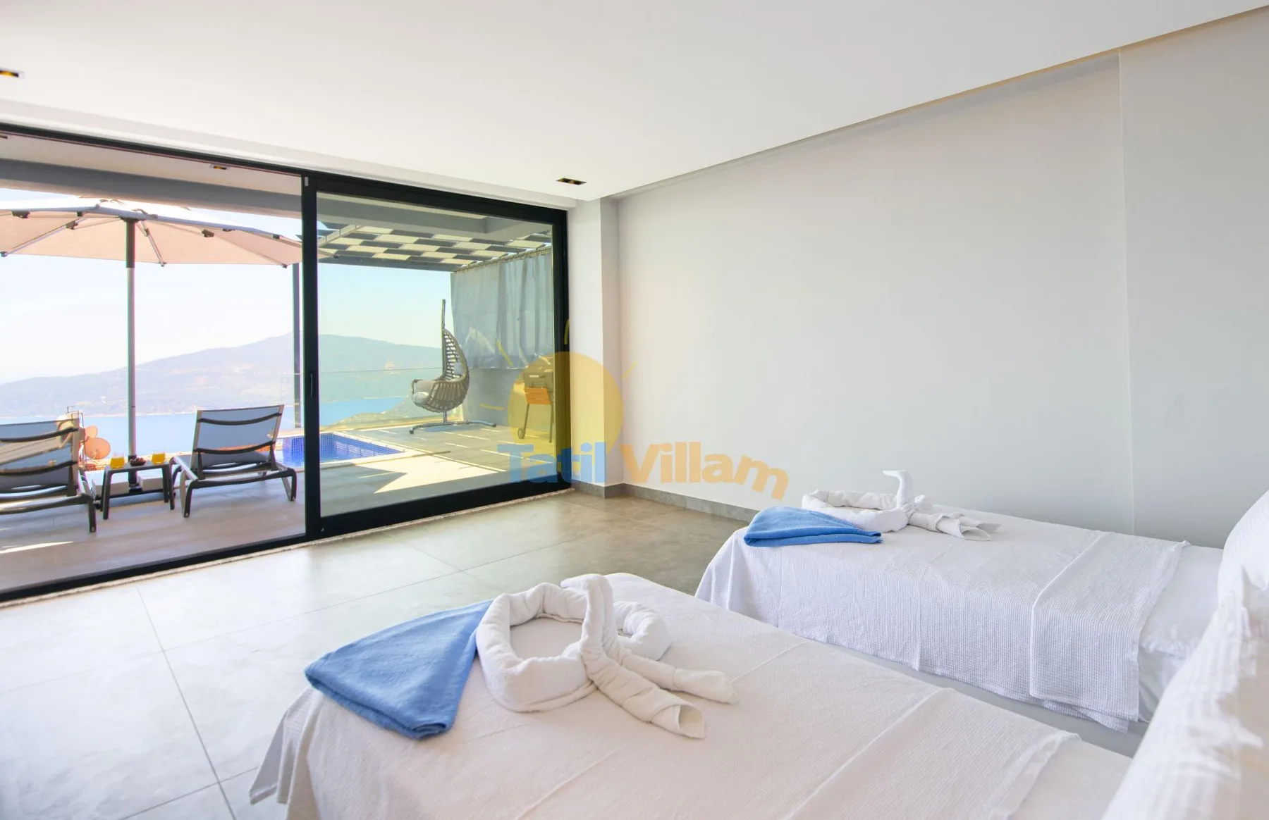 A bedroom with two beds beside sliding glass doors opening onto a patio.