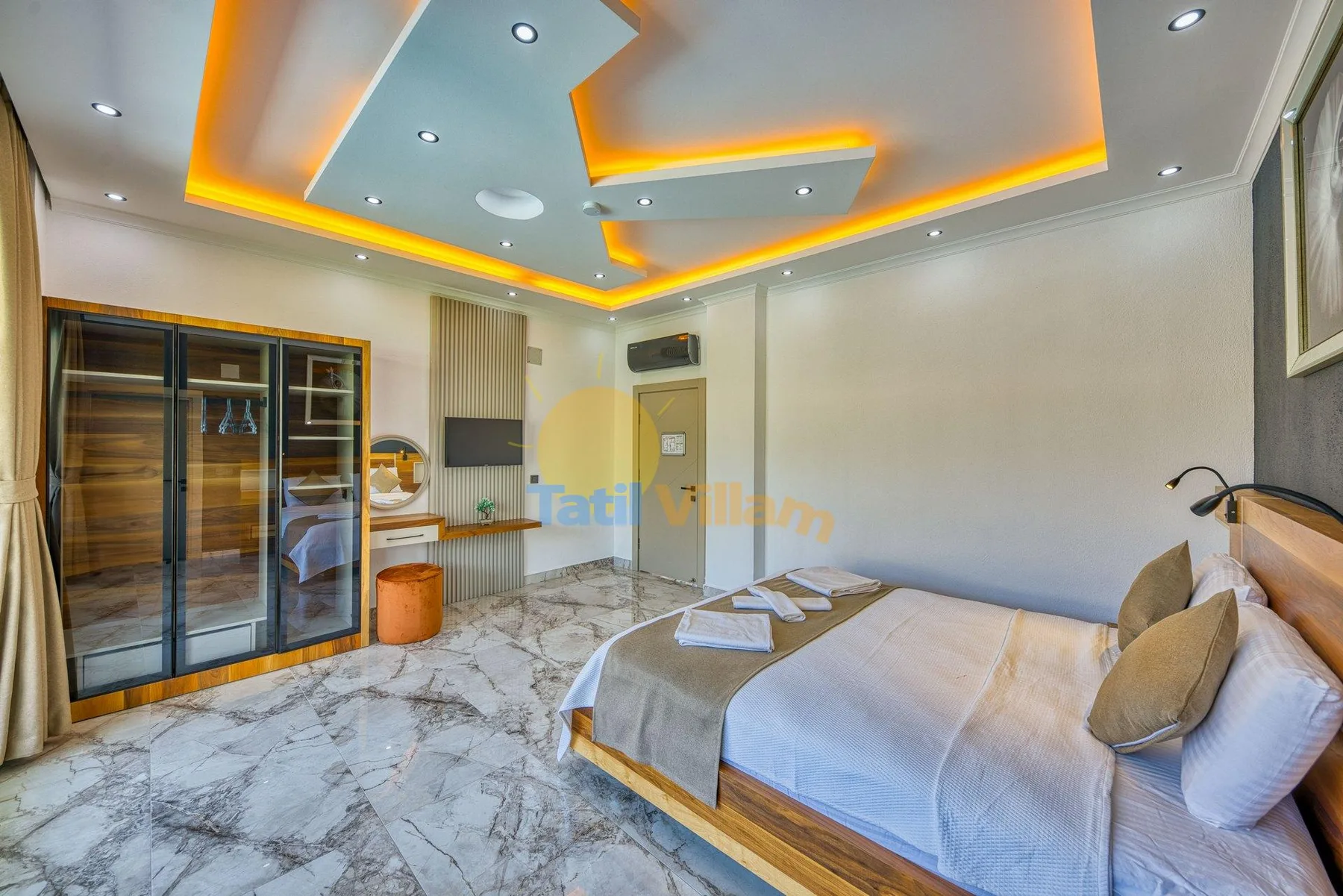 A bedroom with a bed, marble-patterned flooring, and illuminated ceiling details.