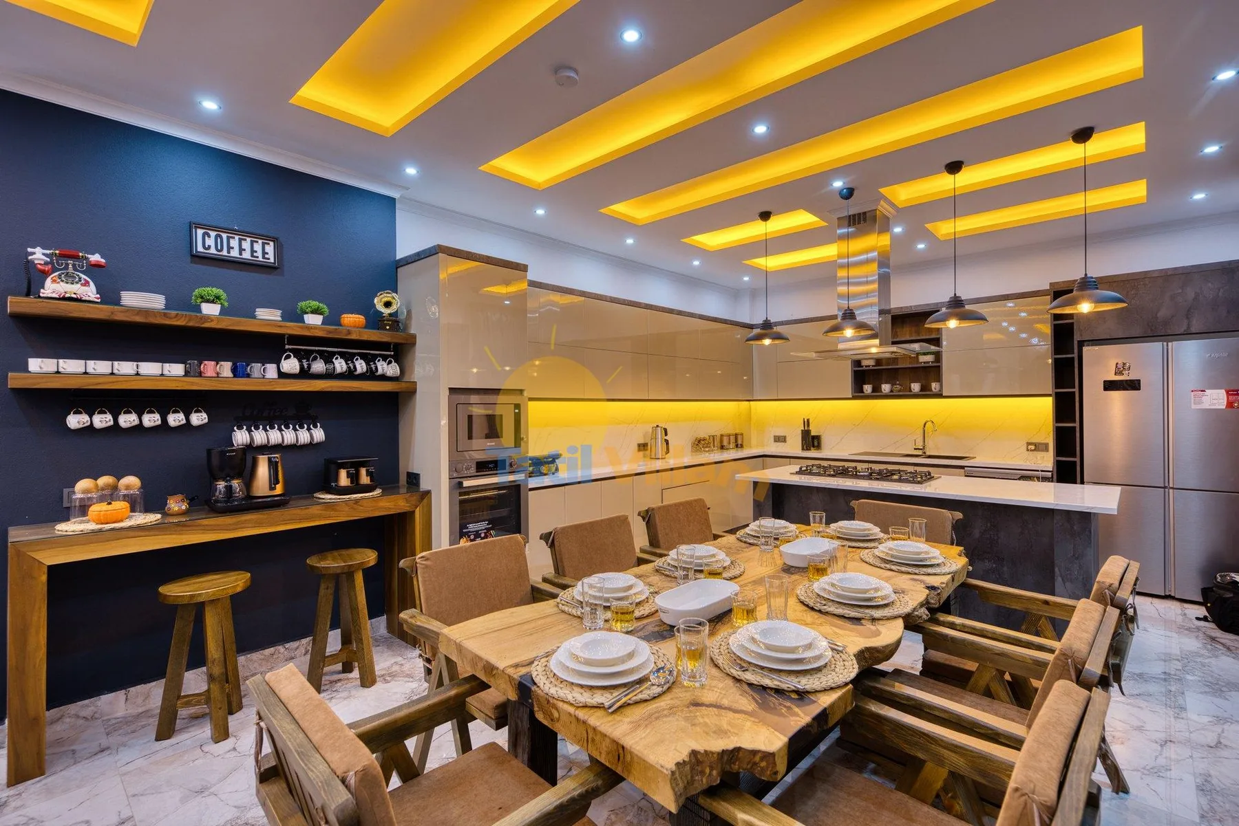 A dining area with a wooden table and chairs beside a kitchen.
