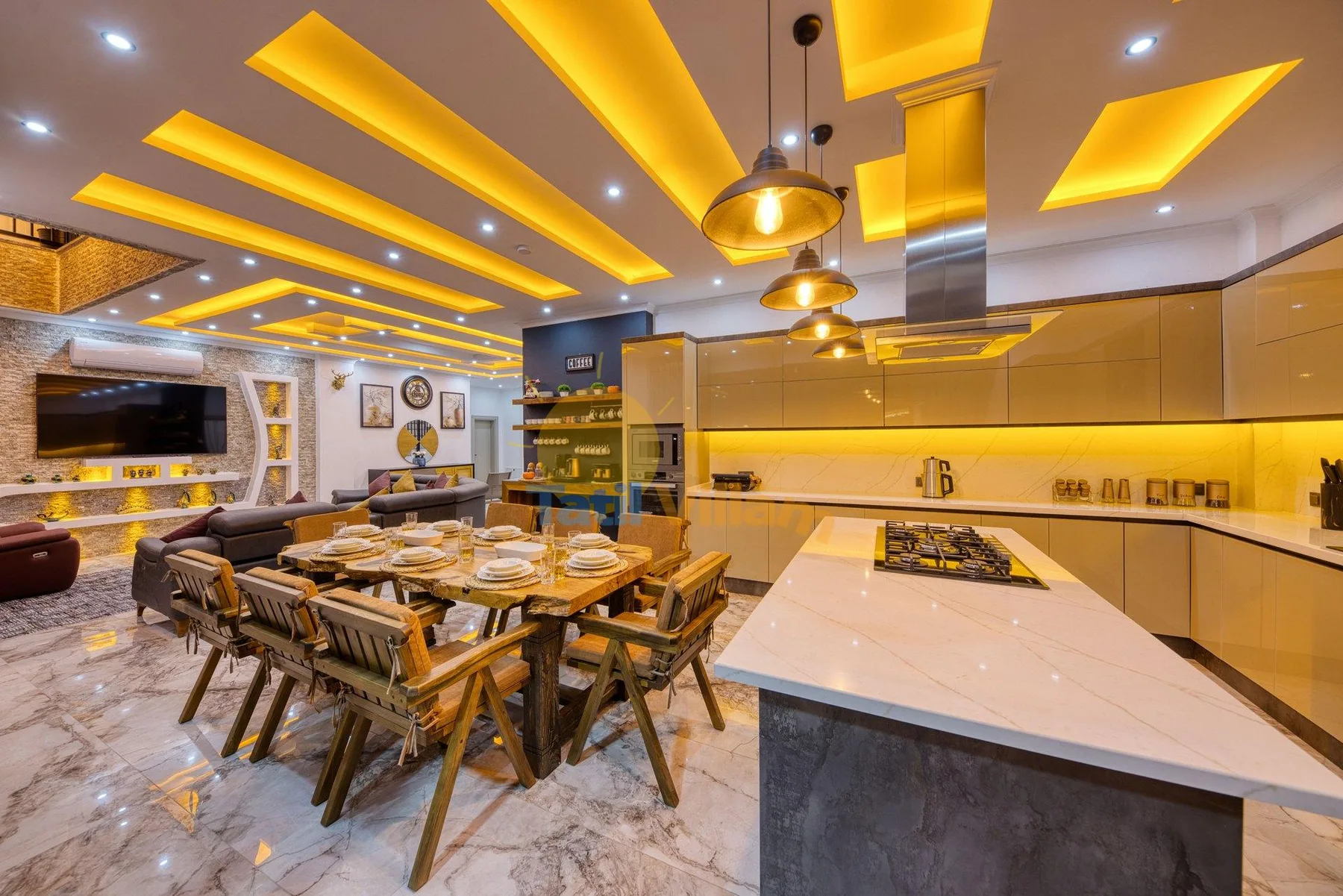 A modern kitchen and dining area with a large island and a dining table.
