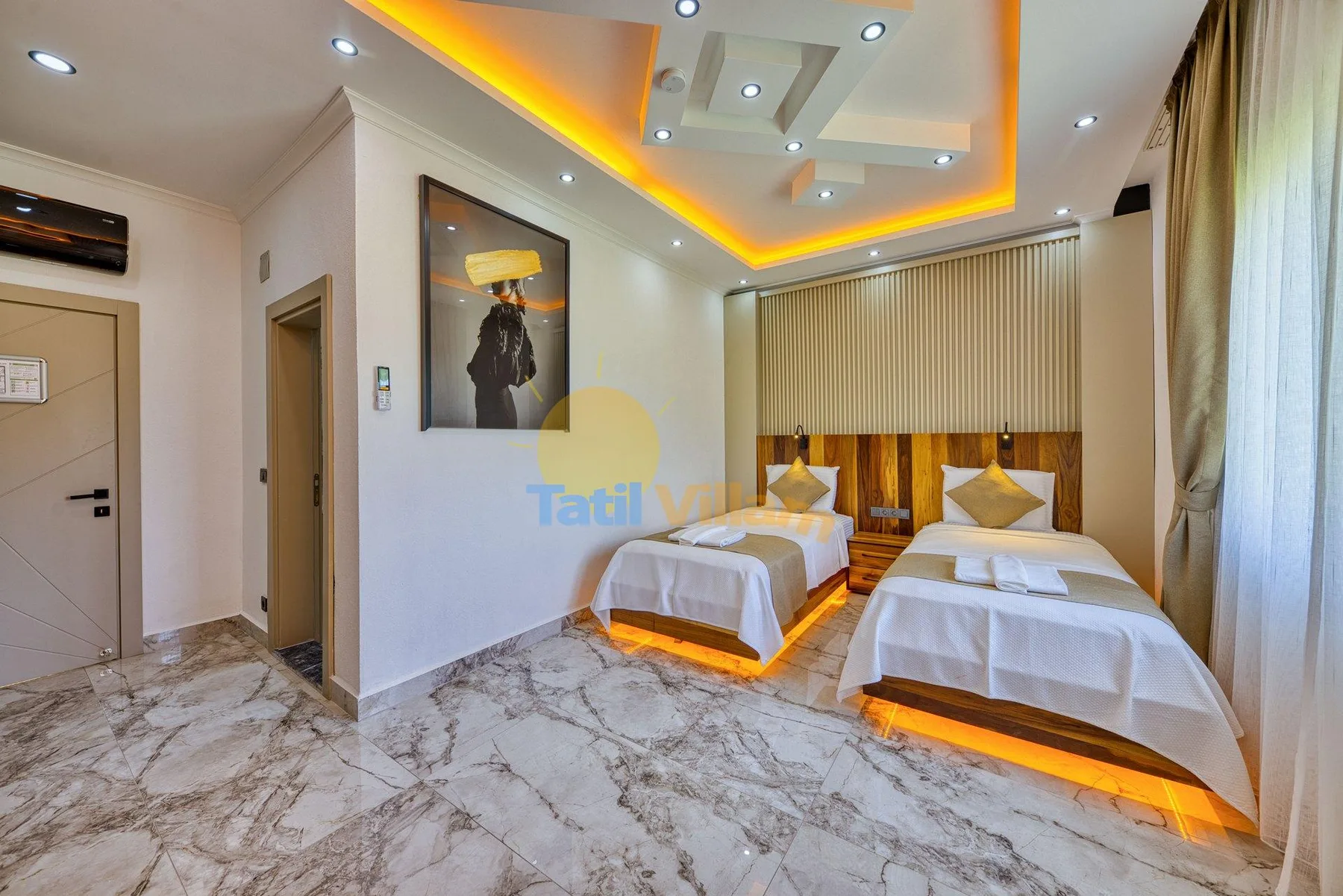 A bedroom with two beds, a wood-paneled headboard, and marble-patterned flooring.