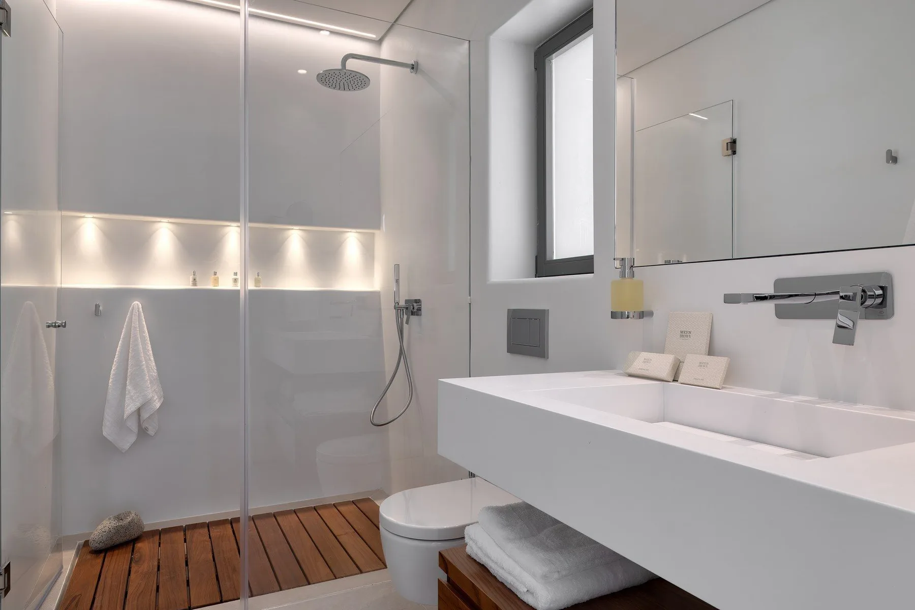 A modern bathroom with a shower, bathtub, and white vanity.