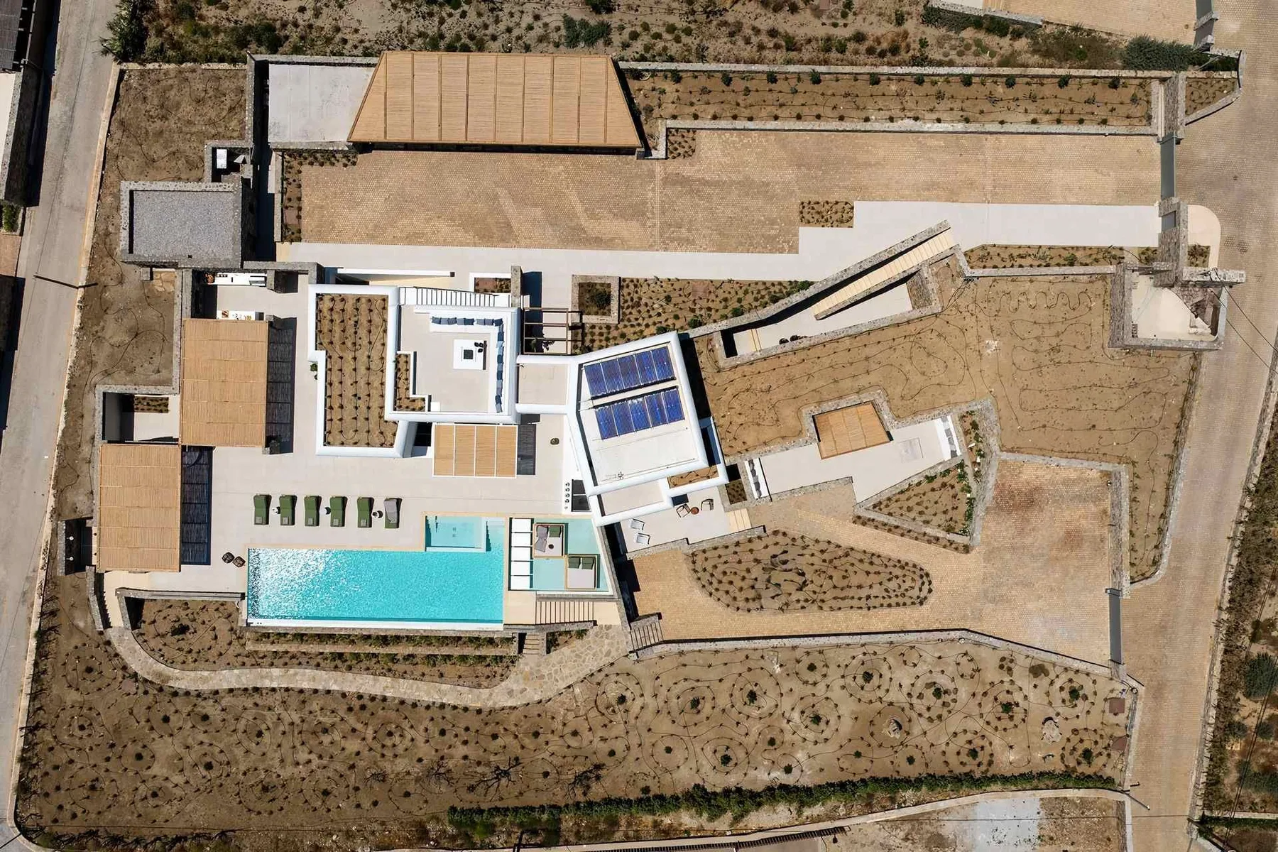 An aerial view of a modern building and surrounding landscaped grounds.