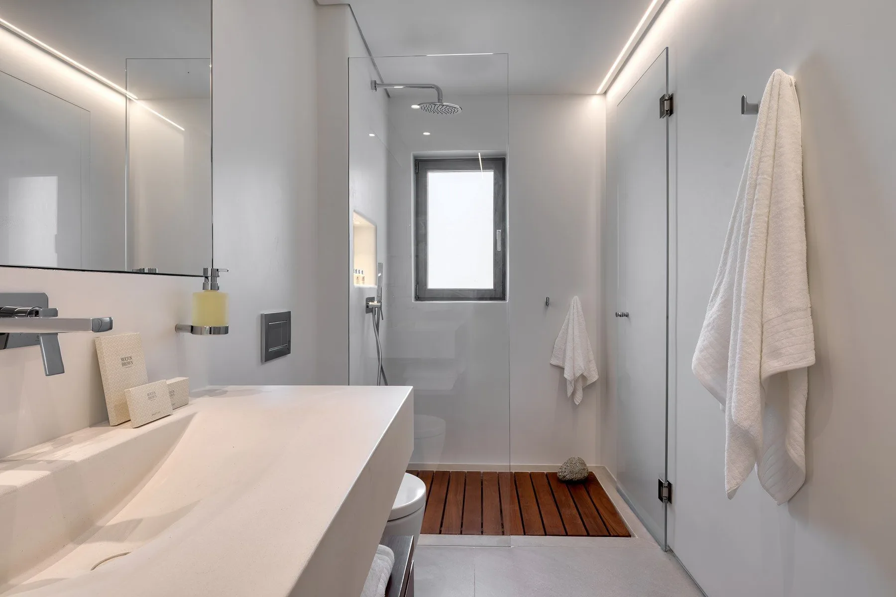 A modern bathroom with a wide vanity and a glass shower area.