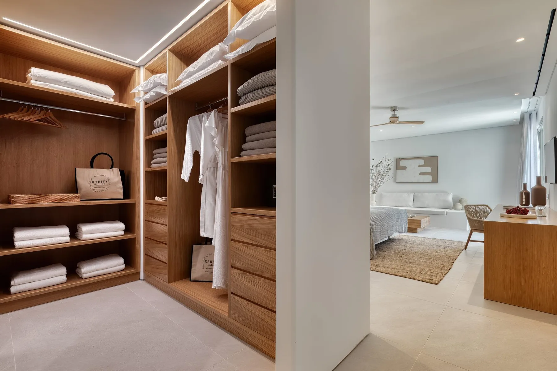 A walk-in closet with open wooden shelving and a bedroom visible beyond.