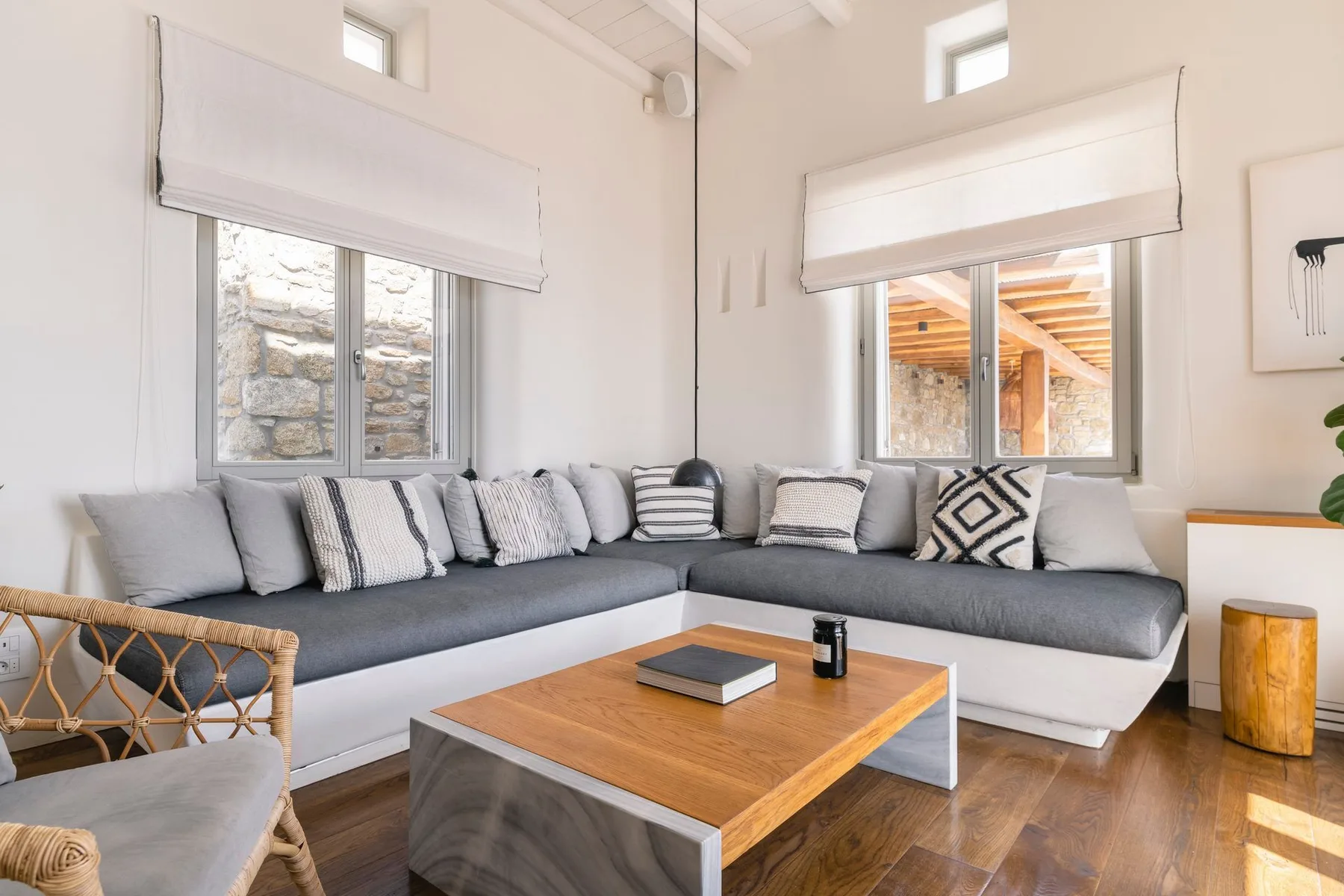 A bright living room with an L-shaped seating area and a wooden coffee table.