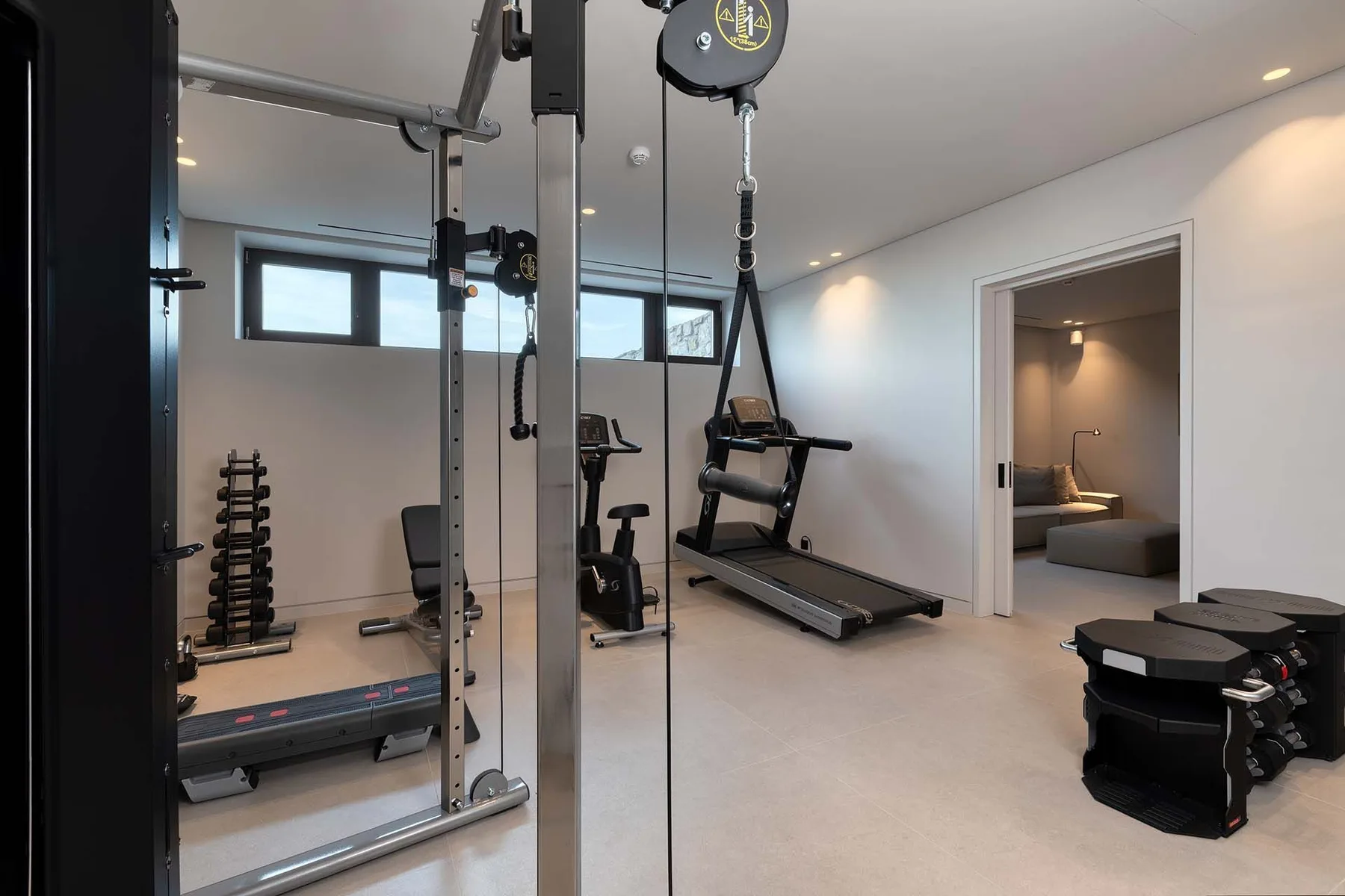 A home gym with exercise equipment and a treadmill.