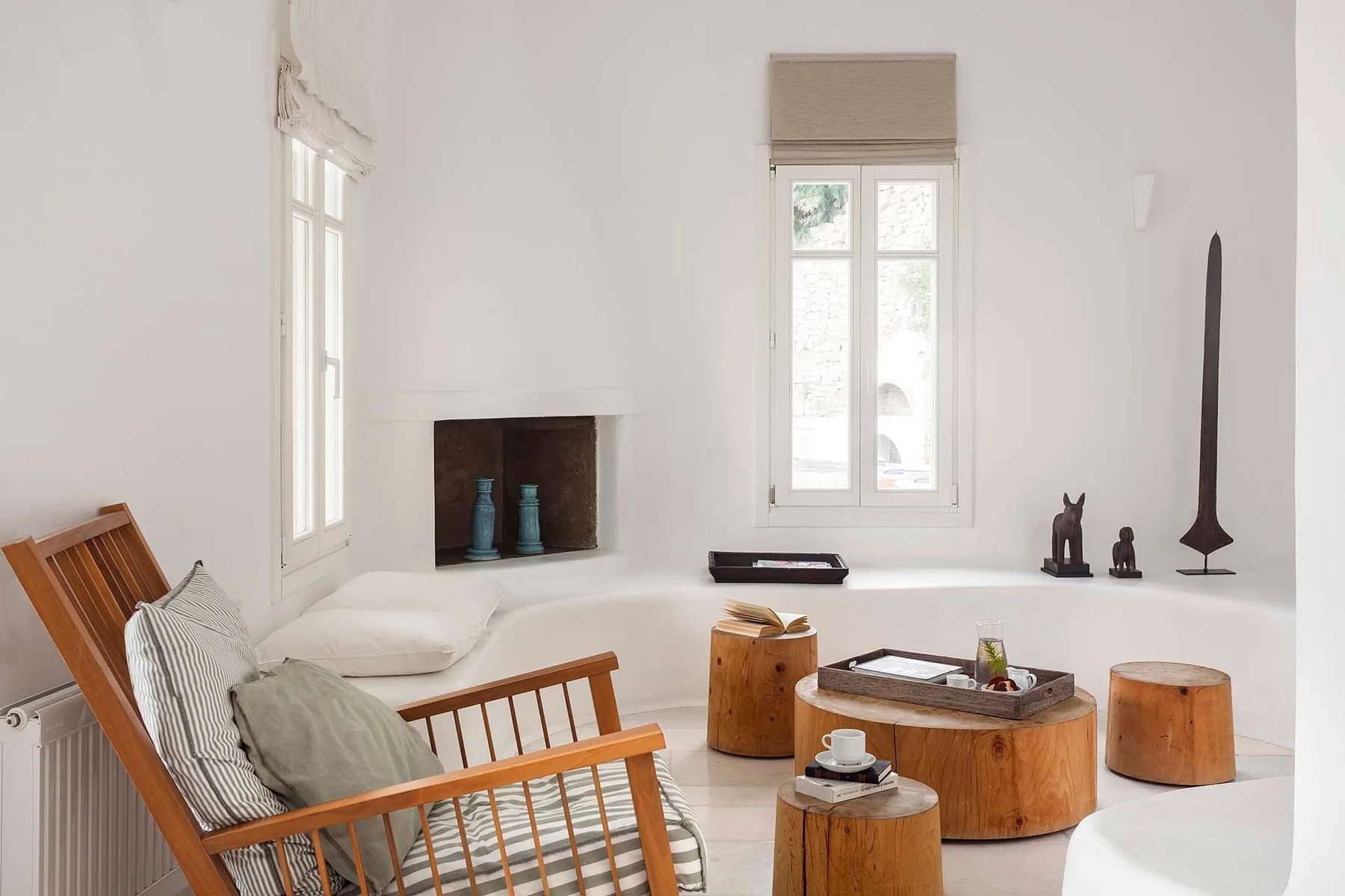 A bright living room with low seating and wooden coffee tables.