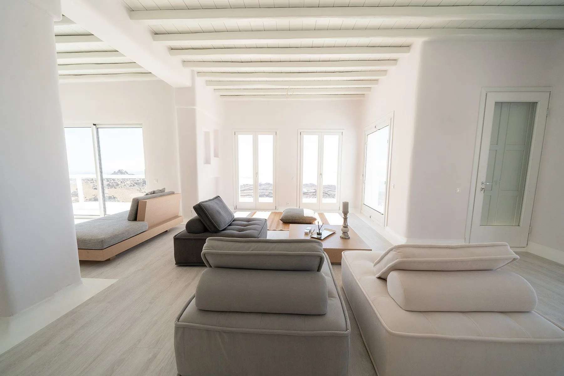 Bright living room with seating and large windows.