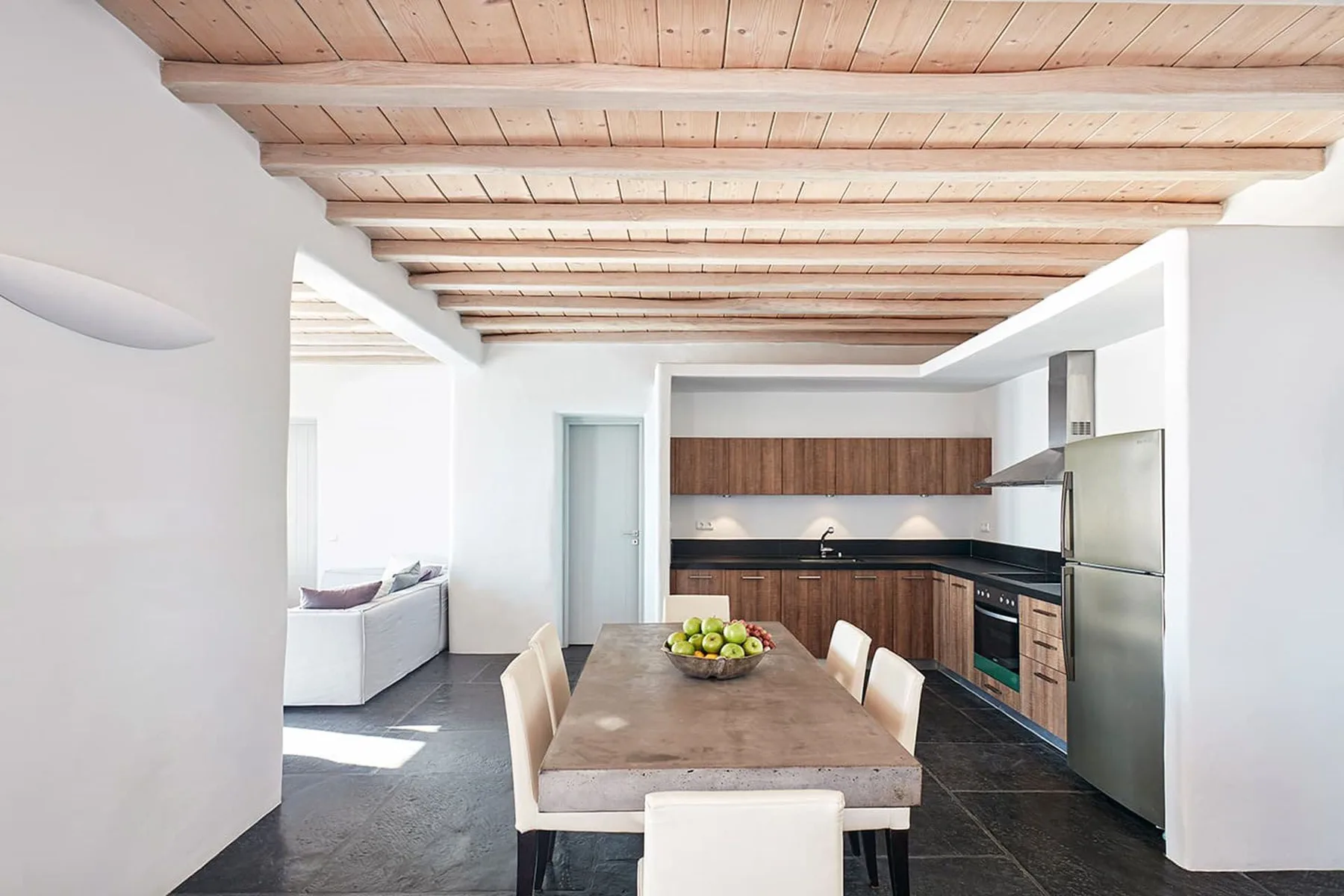 An open-plan kitchen and dining area with a table and seating.