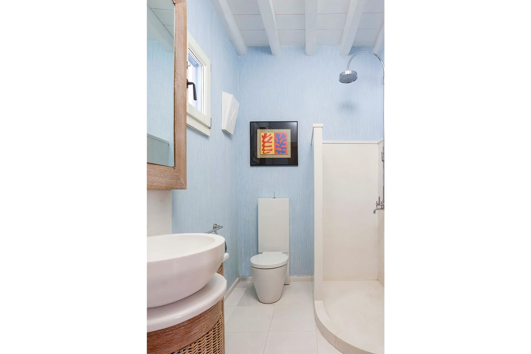 A bathroom with a sink, toilet, and shower.