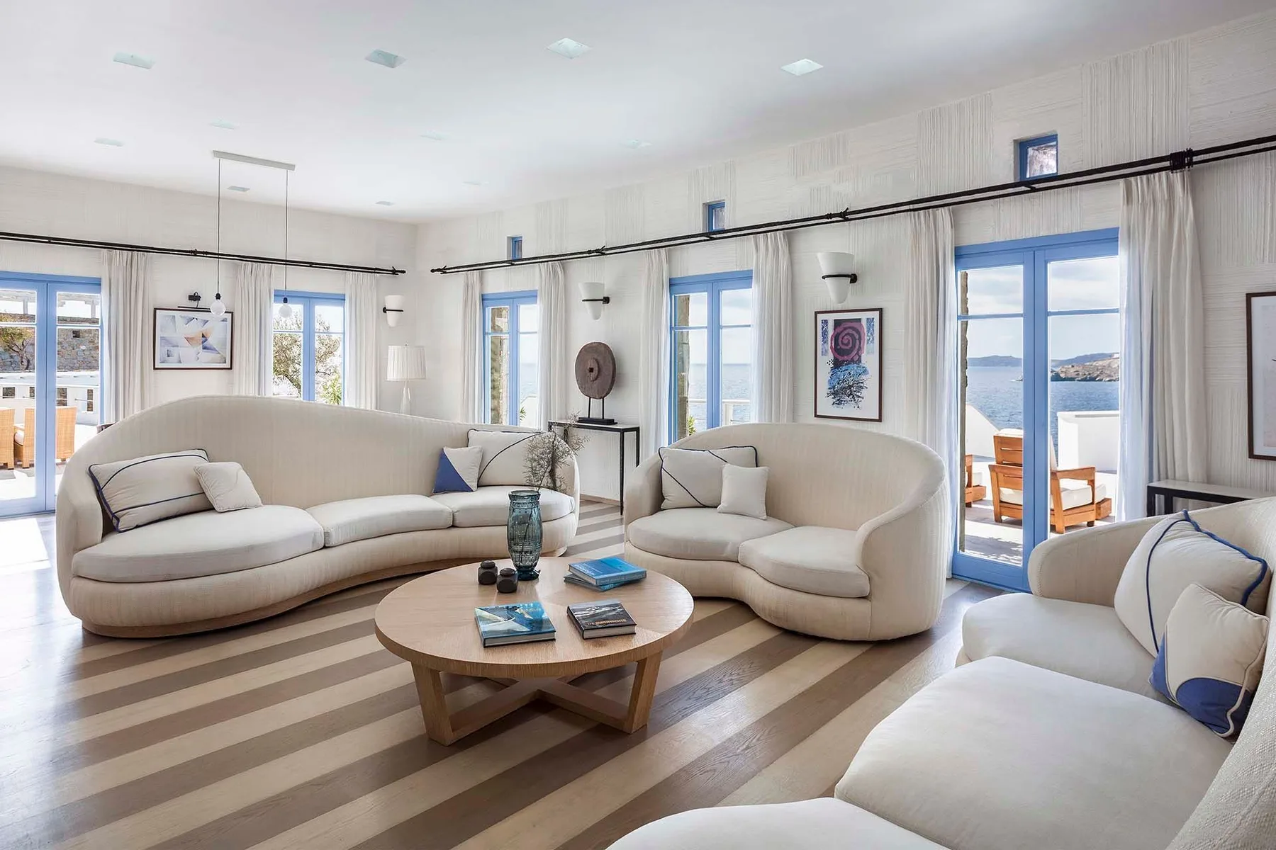 A bright living room with curved seating and a round coffee table.