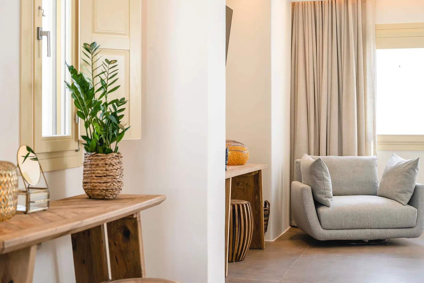 A bright living area with a cushioned seat beside a curtained window.