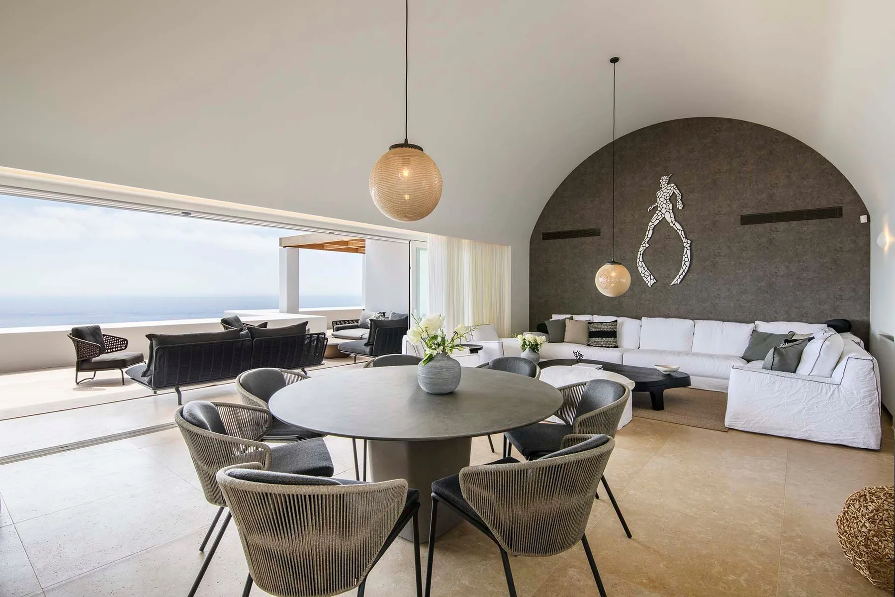 A bright open-plan living and dining area opens onto a terrace.