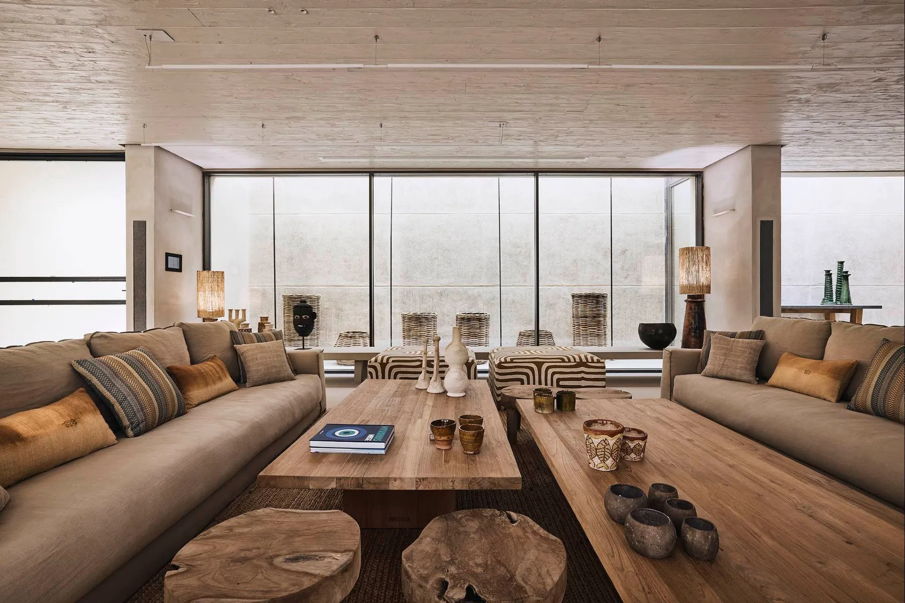 A spacious living room with seating arranged around a low wooden table.