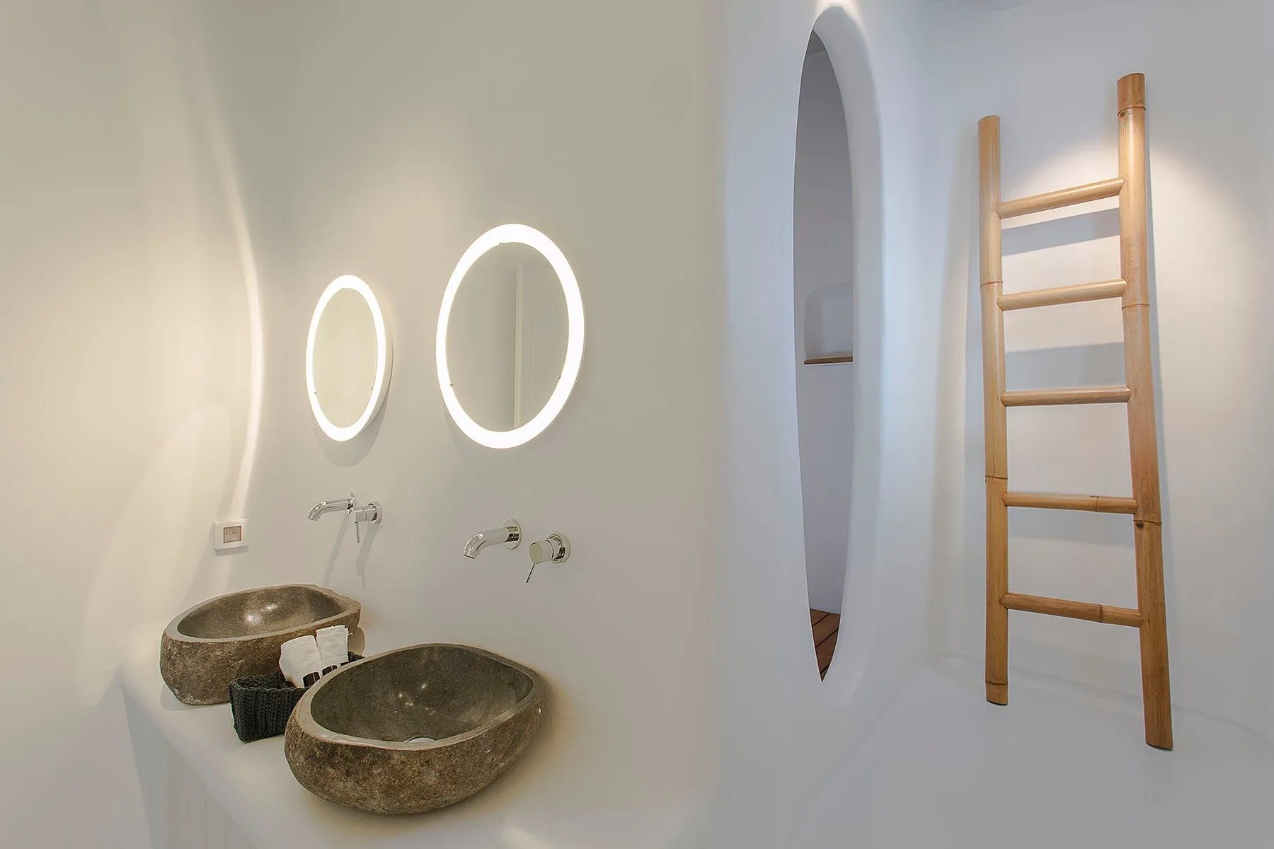 A bright bathroom with two vessel sinks and a wooden ladder against the wall.