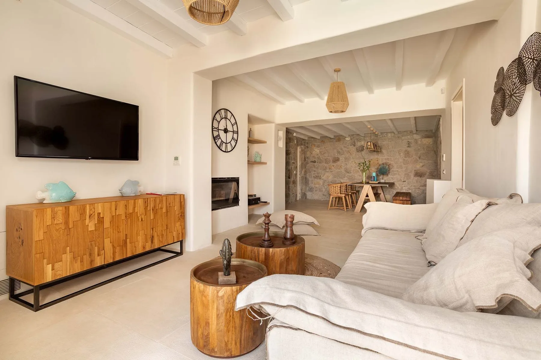 A bright living room with a large sectional sofa and a television.
