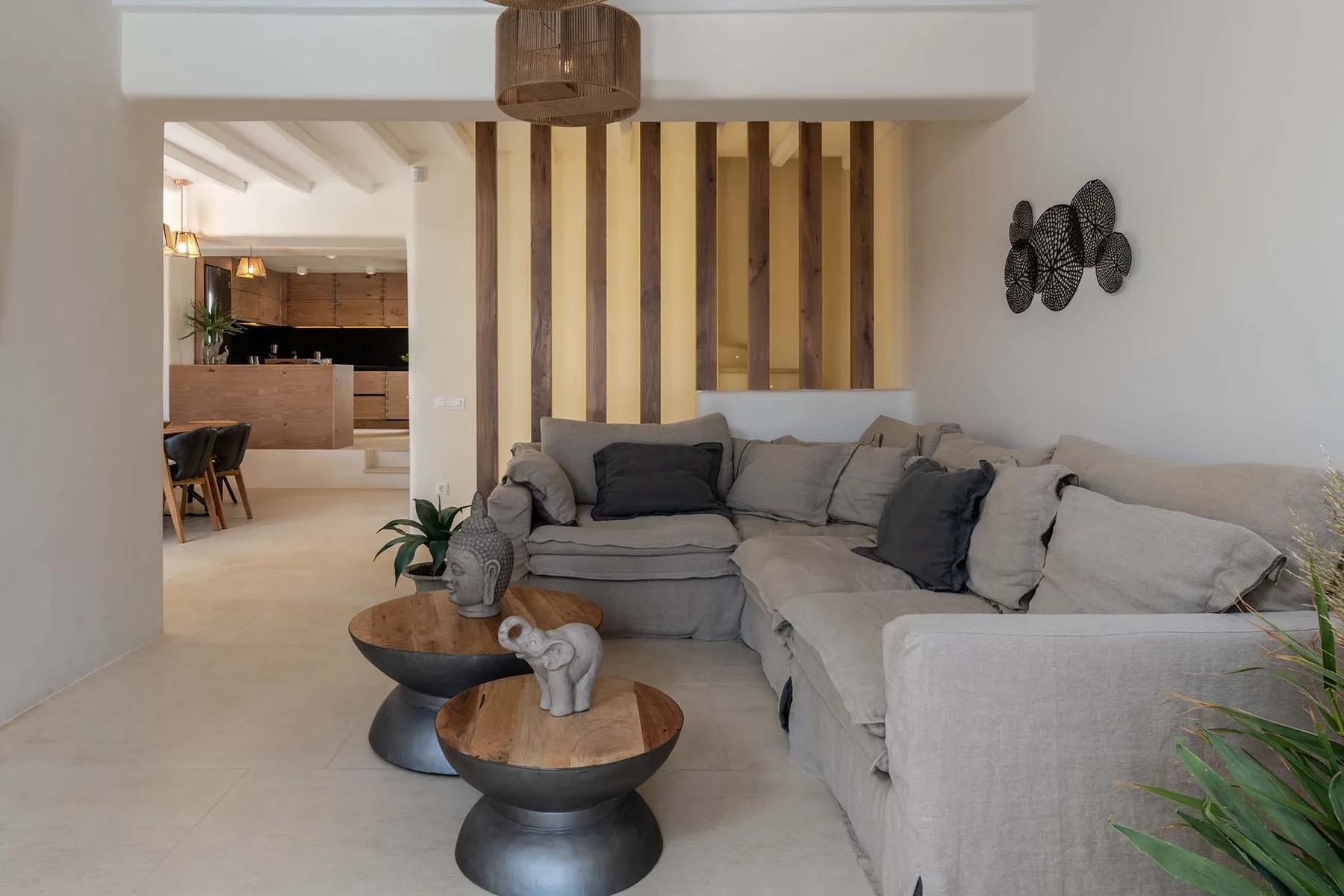 A living room with an L-shaped seating area and two round coffee tables.